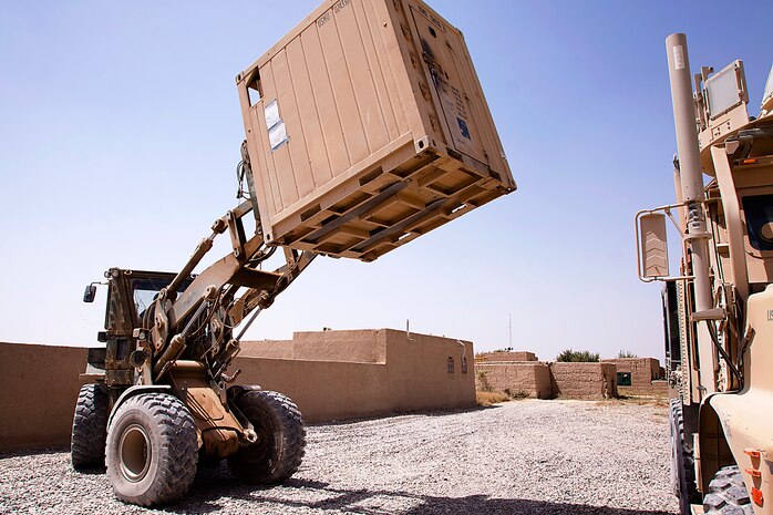 Lance Cpl. Joseph Estrada lifts a giant freezer with a tram here, Aug. 4. Estrada, a native of Staten Island, N.Y., is a maintenance manager for 3rd Truck Platoon. Originating from Marine Corps Bases Japan, 3rd Trucks Platoon is attached to 1st Battalion, 3rd Marine Regiment. Trucks Platoon is responsible for logistical deliveries throughout 1/3’s area of operations.