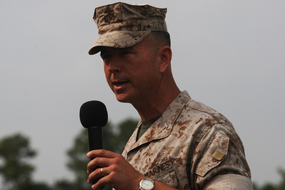 Col. Timothy S. Mundy, outgoing commanding officer of School of Infantry - East, speaks to Marines and attendants of the SOI-EAST change of command ceremony aboard Camp Geiger, Aug. 5. Fitzpatrick is coming into command following a year-long deployment with I Marine Expeditionary Force (Forward) while Mundy is assigned to 2nd Marine Division.