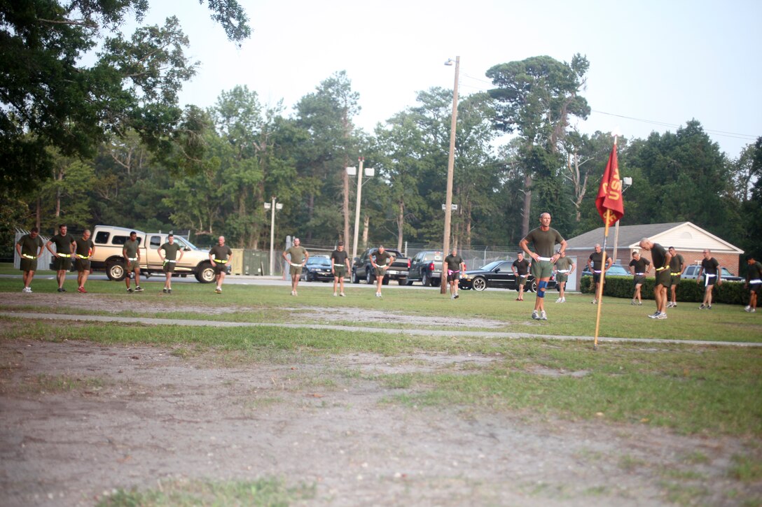 Sgt. Maj. Todd M. Parisi, 26th Marine Expeditionary Unit sergeant major, leads Marines and sailors through cool down stretches after a four mile run at Camp Lejeune, N.C., Aug. 5, 2011. The four-mile run was a unit cohesion event for new personnel. (U.S. Marine Corps photo by Cpl. Christopher Q. Stone)