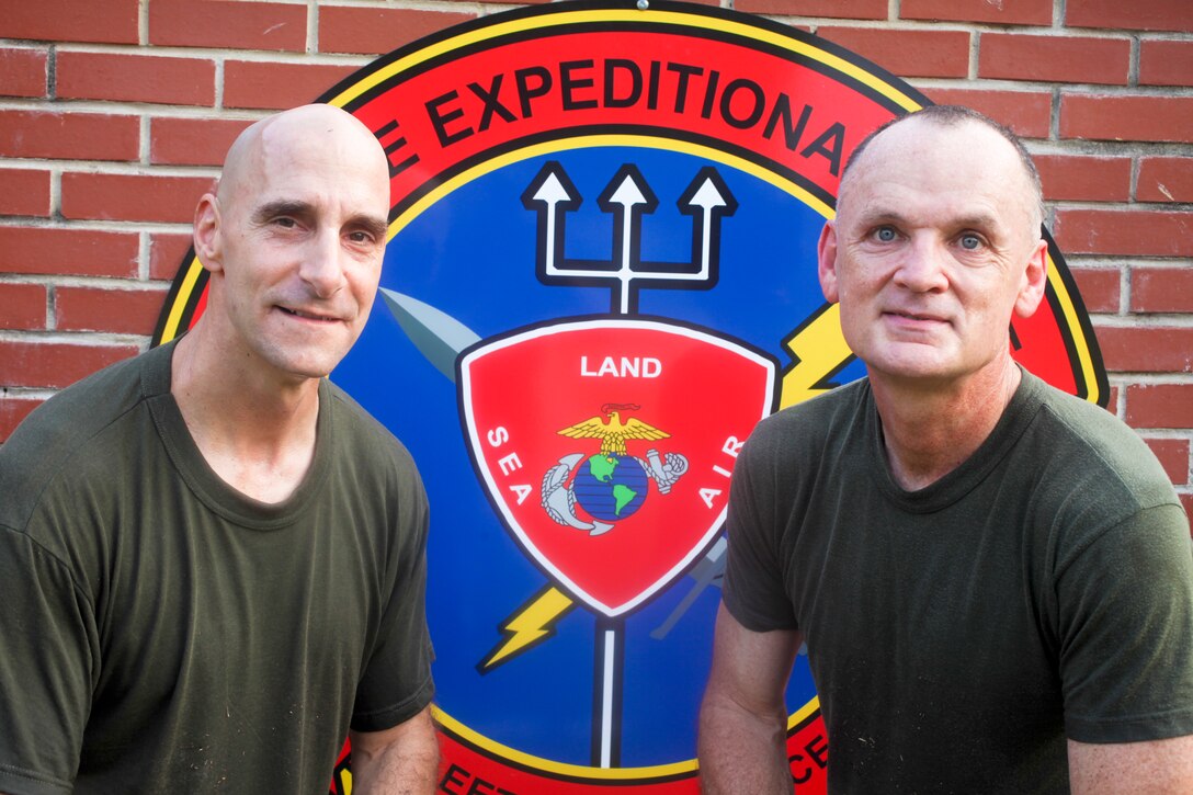 Marine Col. Matthew St. Clair (left), commanding officer of the 26th Marine Expeditionary Unit,::r::::n::poses for a photo with Navy Lt. Cmdr. Troy Todd, the 26th MEU command chaplain, at Camp::r::::n::Lejeune, N.C., Aug. 5, 2011. (U.S. Marine Corps photo by Cpl. Christopher Q. Stone)