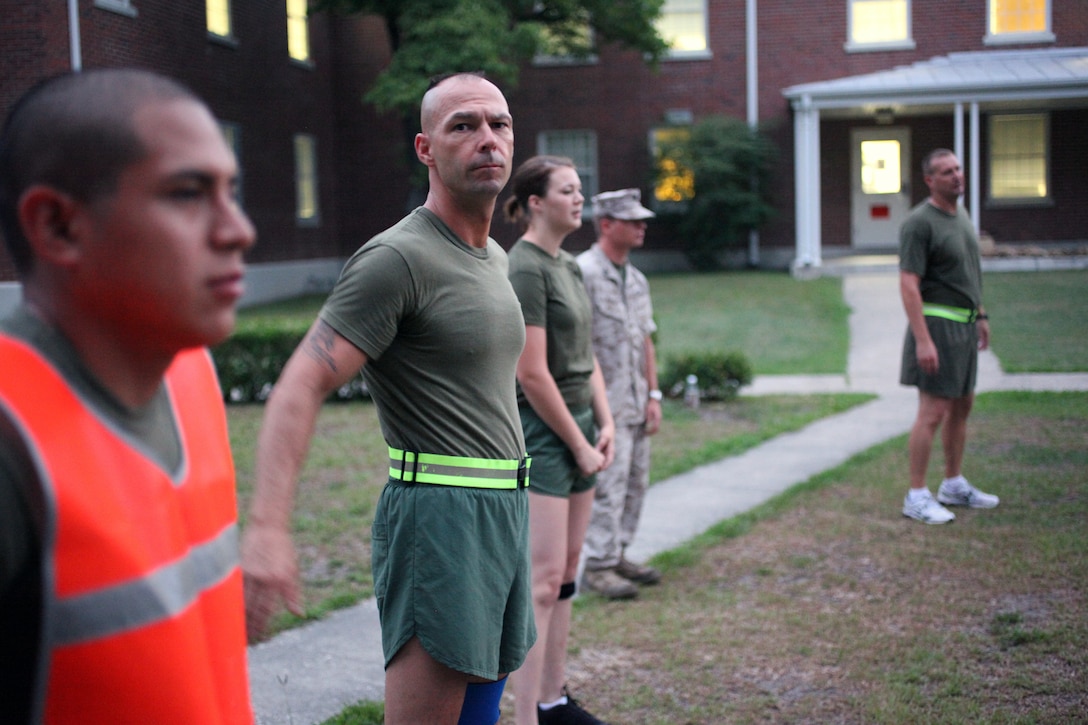 26th Marine Expeditionary Unit sergeant major, Sgt. Maj. Todd M. Parisi, conducts warm up exercises during a command physical training session on Camp Lejeune, N.C., Aug. 5, 2011. The 3.9 mile26th MEU commanding officer, Col. Matthew St. Clair, and 26th MEU sergeant major. (U.S. Marine Corps photo by Gunnery Sgt. Michael K. Kropiewnicki)