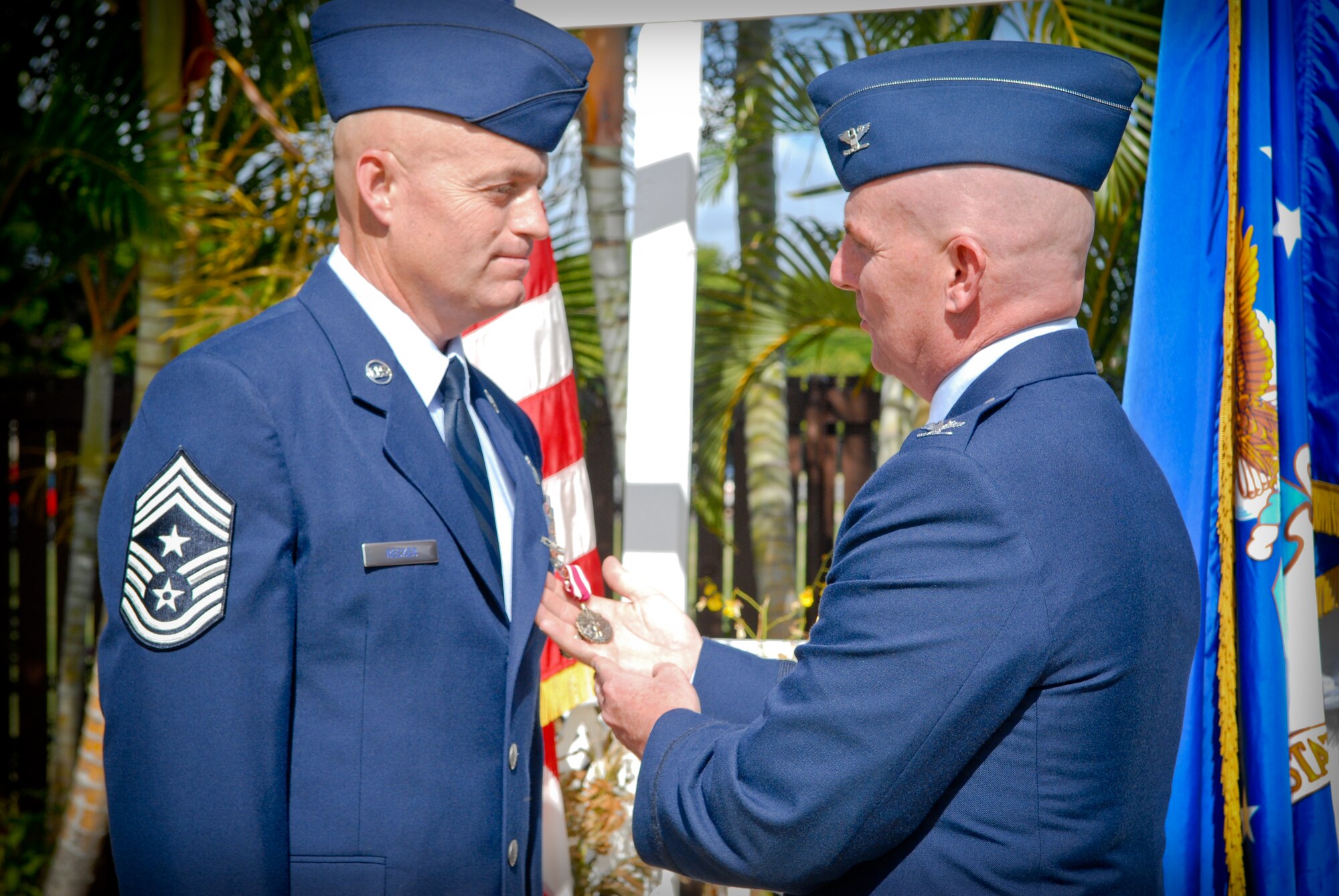 Chief Master Sgt. Craig Recker, 15th Wing command chief master sergeant, accepts a Meritorious Service Medal in front of members of Joint Base Pearl Harbor-Hickam Aug. 5. Col. Sam Barrett, 15 WG commander, presented the medal to Recker who completed his assignment at JBPH-H and will be accepting the command chief master sergeant position at the 37th Training Wing, Lackland Air Force Base, Texas, the largest training wing in the U.S. Air Force. Following the MSM presentation, Barrett said Recker was an amazing Airman who lives the Air Force Core Values daily. (U.S. Air Force photo/Senior Airman Lauren Main)

 