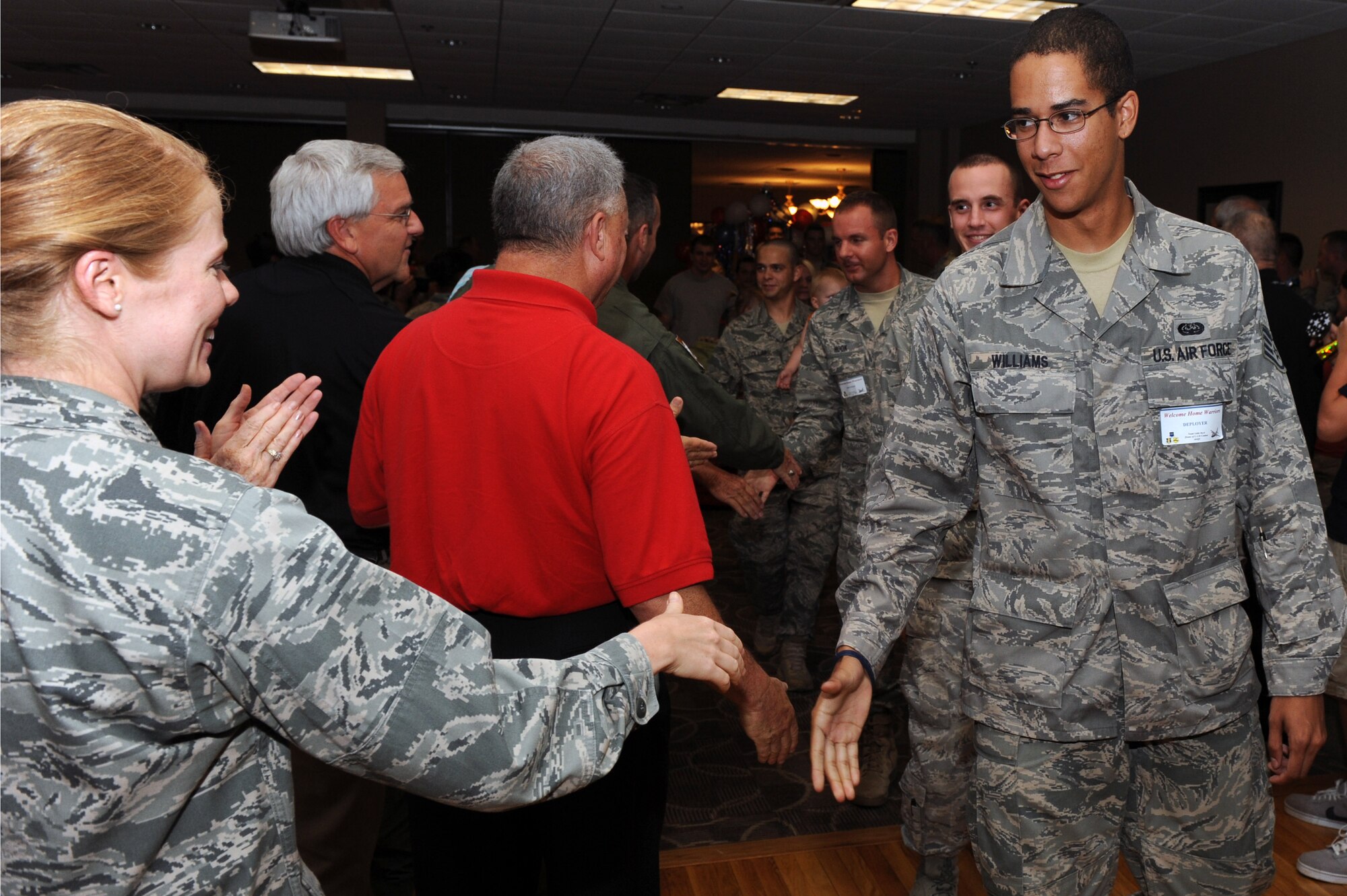 Members of Team Little Rock who recently returned from deployments are greeted by friends and family during the Welcome Home Warriors event Aug. 5, 2011, at Little Rock Air Force Base, Ark. The event is designed to recognize individual deployers who returned home through Little Rock Airport and were not part of a large group. (U.S. Air Force photo by Airman 1st Class Rusty Frank)