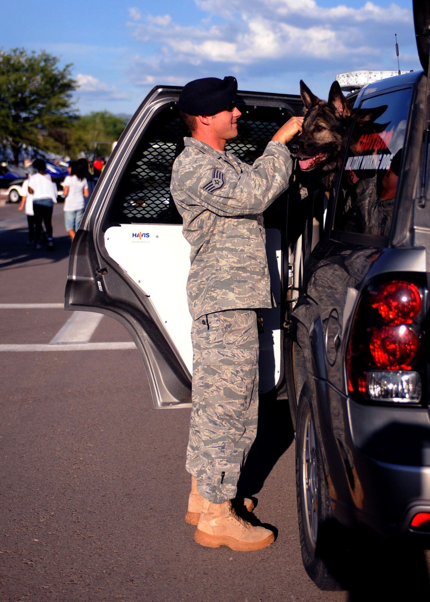 DAVIS-MONTHAN AIR FORCE BASE, Ariz. -- Staff Sgt. Robby Beaudoin, from the 355th Security Forces Squadron, leashes Celo, a military working dog, for a demonstration at National Night Out here Aug. 2. The event also featured many vendors from the local Tucson community. (U.S. Air Force photo/Airman 1st Class Christine Halan)