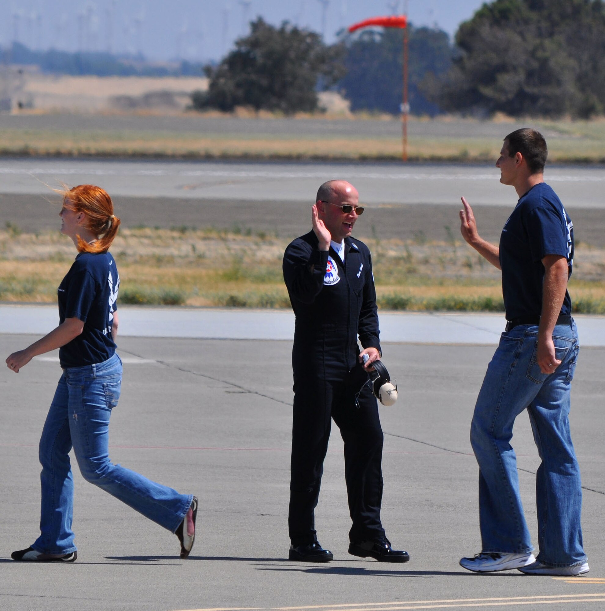 TRAVIS AIR FORCE BASE, Calif. -- One of the elite maintenance team of the U.S. Air Force Thunderbirds "high fives" a new Air Force enlistee July 30. More than 60 young men and women stood as a group on the Travis AFB flight line, during the 2011 Air Power Expo, and were sworn into the Air Force. For those choosing the Reserve, Travis is one of five pilot bases launching a Delayed Enlistment Development and Training Flight. While awaiting a report date to basic military training, enlistees will report to the 349th Air Mobility Wing Flight Leader, Master Sgt. Heather Bradley, for training that will help them make the transition from civilian to Airman. Wearing blue Air Force Reserve tee shirts and blue jeans, they will report on Saturdays of A and B Flight UTA at 7:20 a.m., to the Airman Leadership School. Their curriculum will include uniform standards and inspections, drill and ceremony, Air Force heritage, physical training and more. Right now, there are about 80 enlistees in the program. Volunteers are sought to assist with the training and mentoring. Please contact Sergeant Bradley at 424-1693, or email her at heather.bradley@us.af.mil. (U.S. Air Force photo/Senior Master Sgt. Ellen L. Hatfield)
