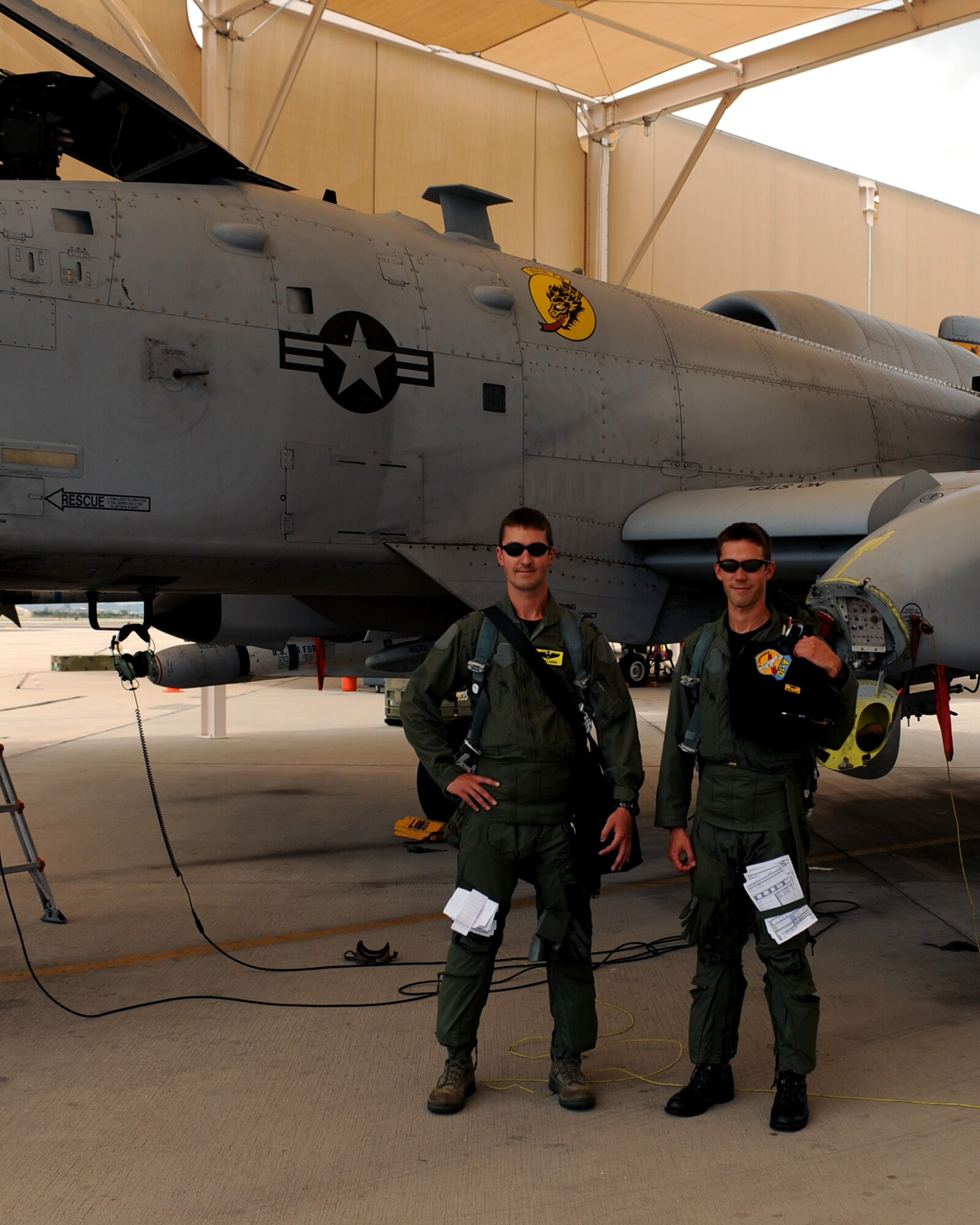 DAVIS MONTHAN AIR FORCE BASE, Ariz. – Capt. Eric and Capt. Michael Fleming, 357th Fighter Squadron pilots, stand in front of an A-10C on the flightline here Aug. 3. Capt. Michael Fleming joined the Air Force four years after his brother. (U.S. Air Force photo/Airman 1st Class Christine Halan)