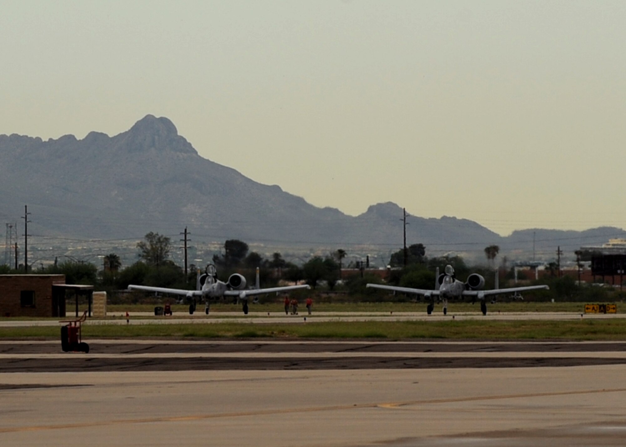 DAVIS MONTHAN AIR FORCE BASE, Ariz. – Capt. Eric and Capt. Michael Fleming, 357th Fighter Squadron pilots, wait in the A-10Cs to take off on the flightline here Aug. 3. Capt. Michael Fleming joined the Air Force four years after his brother. (U.S. Air Force photo/Airman 1st Class Christine Halan)