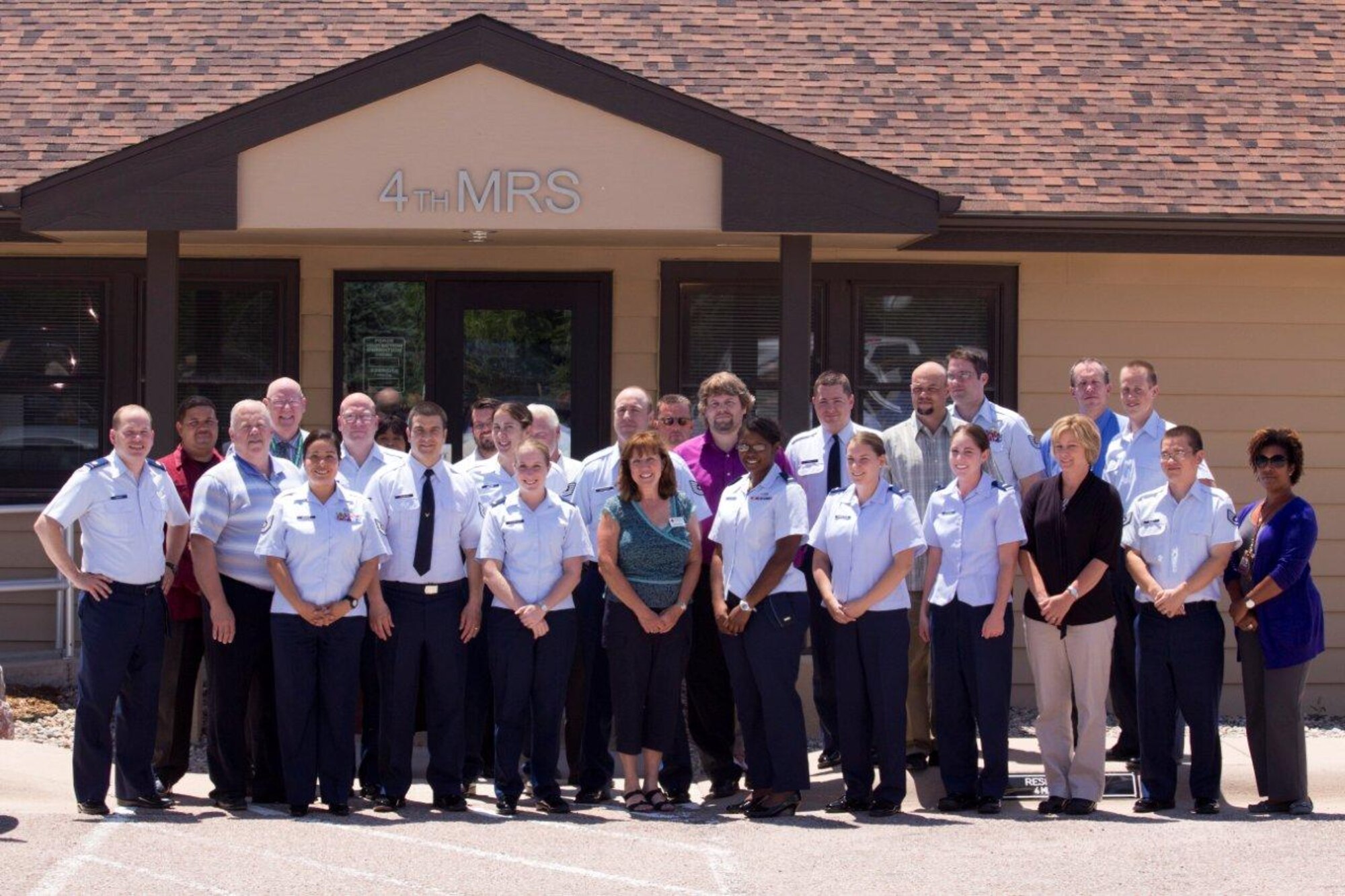 4th Manpower Requirements Squadron and Frances Scott (center), Services to the Armed Forces Community Outreach coordinator for the American Red Cross. Members of the 4th MRS raised more than $600 by collecting loose change to send to natural disaster victims in the Southeast region of the United States. (Courtesy photo)