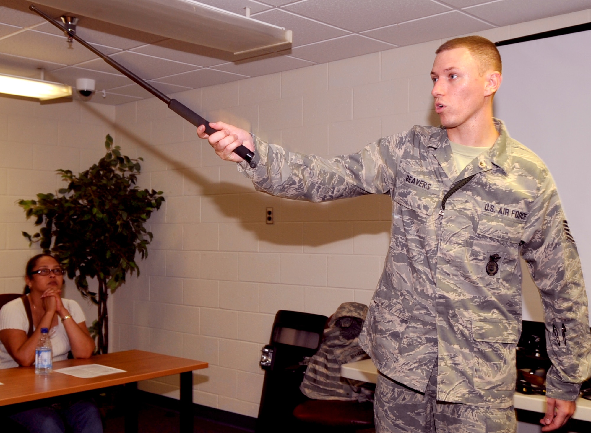 Tech. Sgt. Christopher Beavers, 633rd Security Forces Squadron NCOIC of community policing, demonstrates the use of an asp during a citizen’s police academy class at Bethel Manor Aug. 4, 2011.  The class is to educate participants in techniques that Security Forces members use on a day-to-day basis.  (U.S. Air Force photo by Staff Sgt. Logan Tuttle/Released)