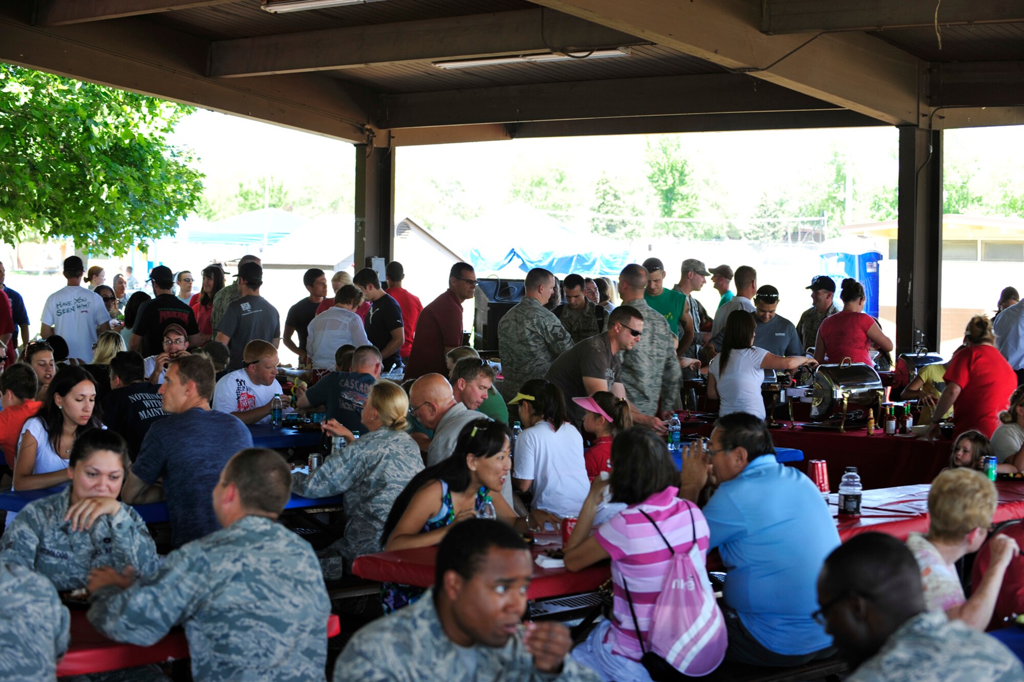 The tables filled up fast with Airmen and their families enjoying the fare provided by Gastronomy Inc. (U.S. Air Force photo by Kim Cook)