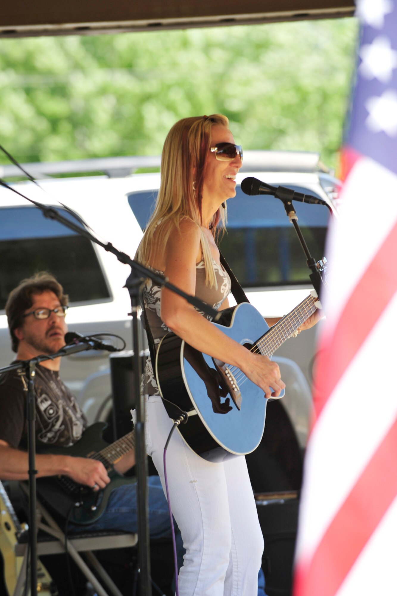Singer and backup guitarist DeAnn Sorensen and guitarist Dan Nobles of Red Shot Pony perform during the 10th annual Salute to our Nation's Defenders Picnic. (U.S. Air Force photo by Kim Cook)
