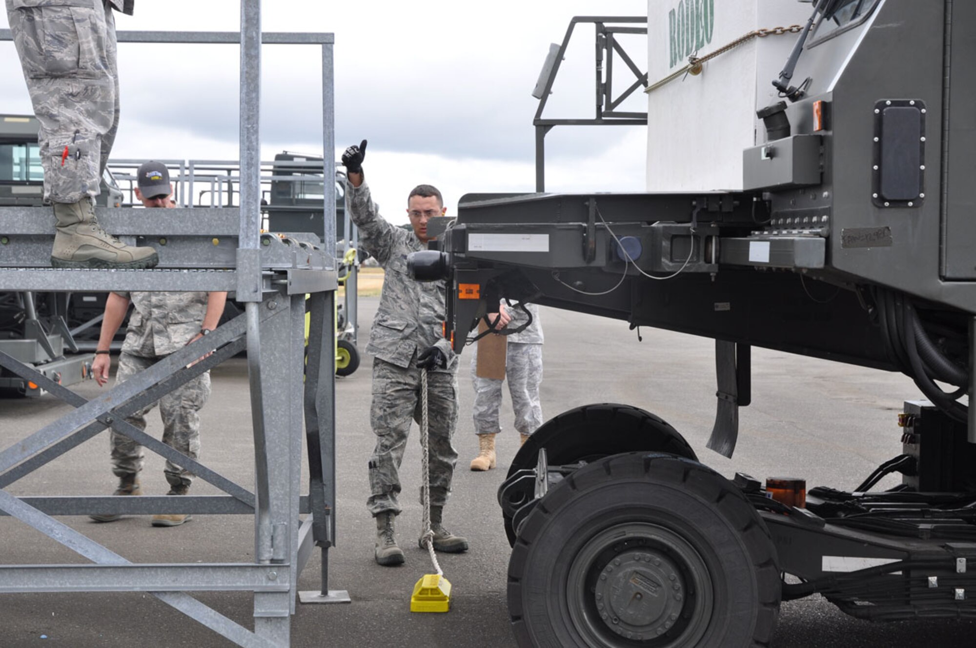 Staff Sgt. Cody Phillips, 773rd Logistics Readiness Squadron and Team Alaska Aerial Port Participant signals to the Haversen Loader driver during the Haversen Loader Aerial Port Event at the 2011 Air Mobility Command Rodeo on July 26.  (U.S. Air Force photo/Capt. Corinna Jones)