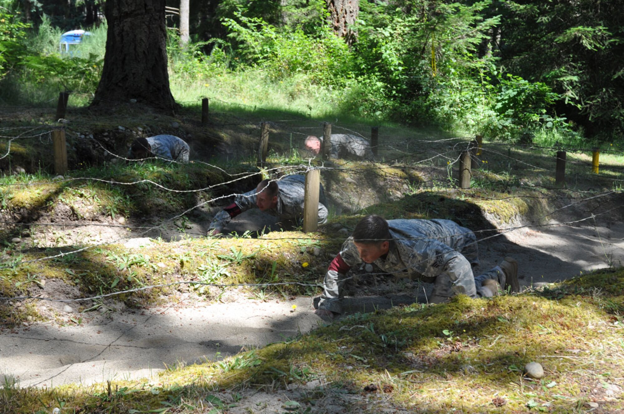 673rd Air Base Wing Security Forces members Senior Airman Brent Hayes, Senior Airman Payton Barnes, Senior Airman Evan Gillies and Airman 1st Class Stephen Becker perform the low crawl during the Combat Skills Endurance event at the 2011 Air Mobility Command Rodeo on July, 28. Team Alaska was named Best Security Forces Combat Skills Endurance Team.  (U.S. Air Force photo/Capt. Corinna Jones)
