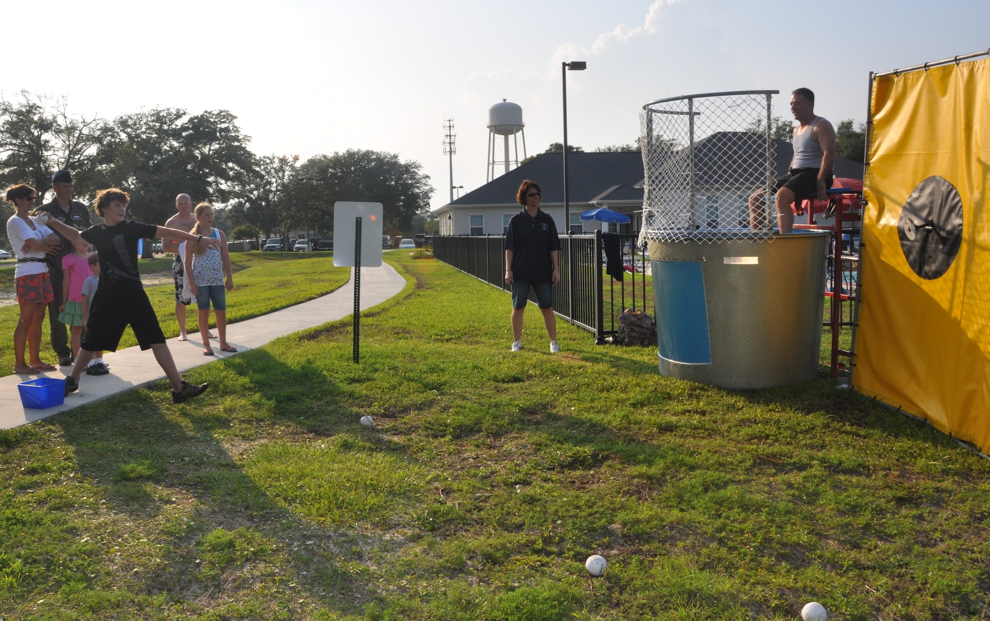 Patrick Grund attempts to dunk Chief Master Sgt. Anthony Grizzard in the dunk pool Aug. 2 during Tyndall’s National Night Out event. Balfour Beatty Communities, Tyndall Community Police and Base Partners held the event to raise awareness about crime prevention at Tyndall.  (U.S. Air Force photo by Senior Airman Veronica McMahon)