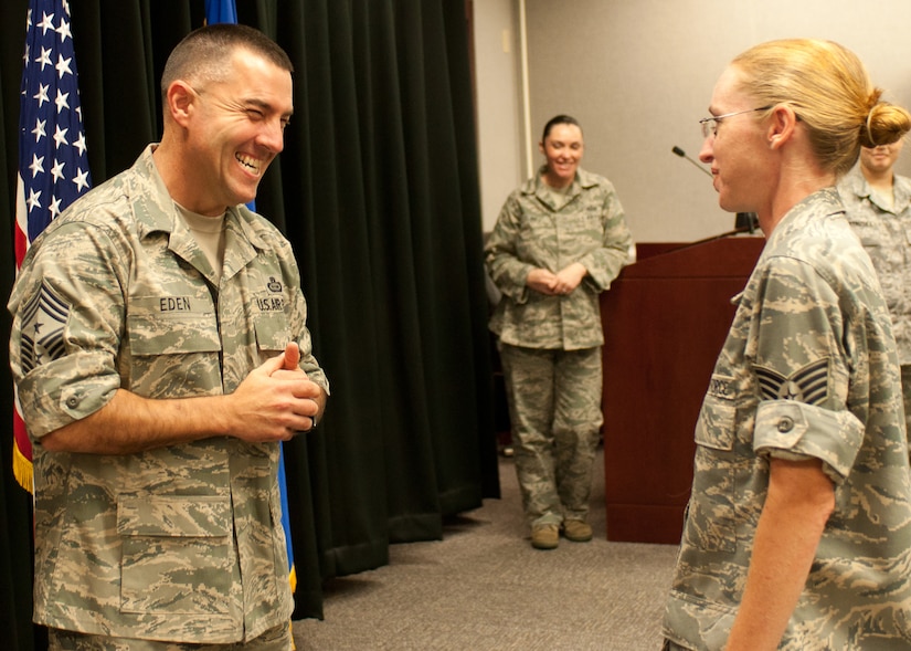 Chief Master Sgt. Troy Eden, new command chief at the 480th Intelligence, Surveillance and Reconnaissance Wing, Langley Air Force Base, Va., shares a story with Tech. Sgt. Connie Howcraft, 480th ISR Wing non-commissioned officer in charge of wing training, during one of his rounds to meet Airmen. One of Eden's top priorities is to meet the men and women of the 480th ISR Wing and hear about their successes as well as their challenges. (U. S. Air Force photo/Senior Airman Jonathan Muller)