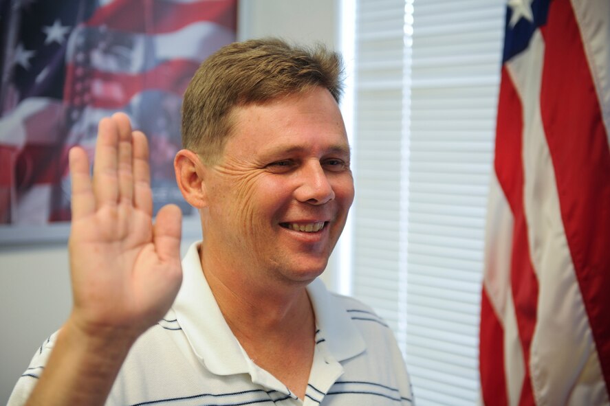 Scott Long recites the oath of enlistment during a ceremony in Valdosta, Ga., July 28, 2011. After a 19-year break in service, Long said his biggest challenge in reenlisting was making sure he was still physically and medically qualified. (U.S. Air Force photo by Staff Sgt. Jamal D. Sutter)