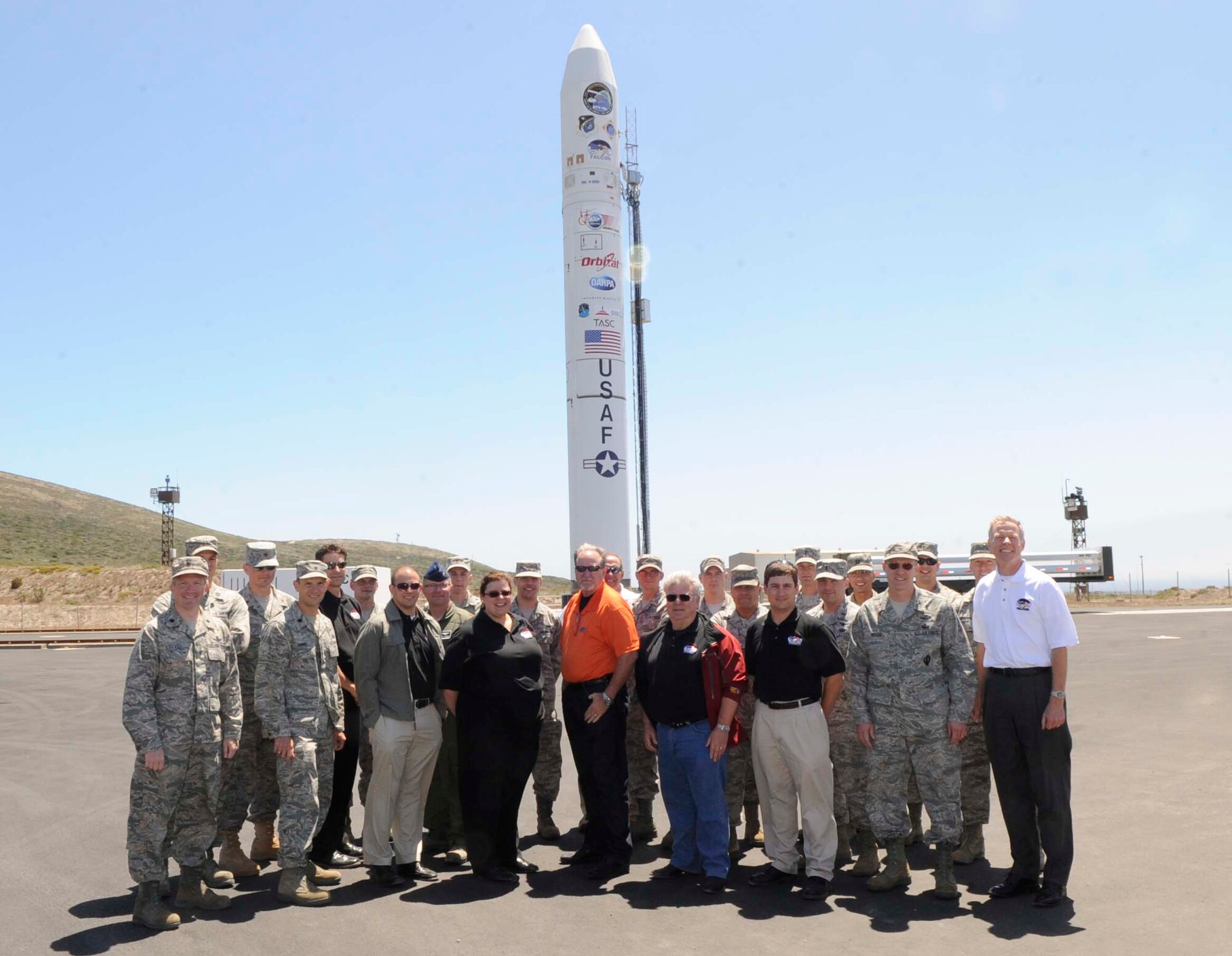 VANDENBERG AIR FORCE BASE, Calif. -- Members from the 30th Launch Group, 1st Air and Space Test Squadron, Orbital Sciences Corporation, Space Port Systems International, Space Development and Test Directorate, Space and Missile Center and Defense Advanced Research Projects Agency pose in front of a Minotaur IV rocket at Space Launch Complex-8 here Wednesday, Aug. 3, 2011. The Minotaur IV will carry the HTV-2 scheduled to launch Aug. 10 between 7 a.m. and 1 p.m. (U.S. Air Force photo/Staff Sgt. Scottie McCord)