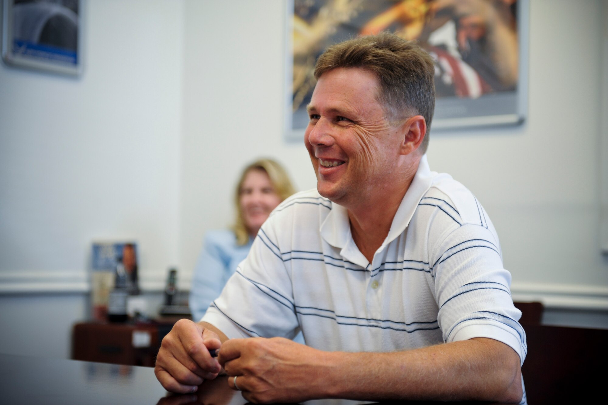 Scott Long, prior active duty Airman, shares a smile moments before enlisting into the Air Force Reserves July 28, 2011, in Valdosta, Ga. Long separated from active duty in 1992 after serving  11 years. (U.S. Air Force photo by Staff Sgt. Jamal D. Sutter/Released)