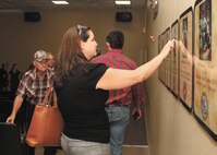Kathy Rusk places her hand over Colton's placard following the military working dog handlers’ memorial ceremony. (U.S. Air Force photo/Robbin Cresswell)