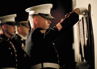Marine Sgt. Andrew Reid, 341st Training Squadron instructor, places Lance Cpl. William H. Crouse, IV's placard on the memorial wall. (U.S. Air Force photo/Robbin Cresswell)