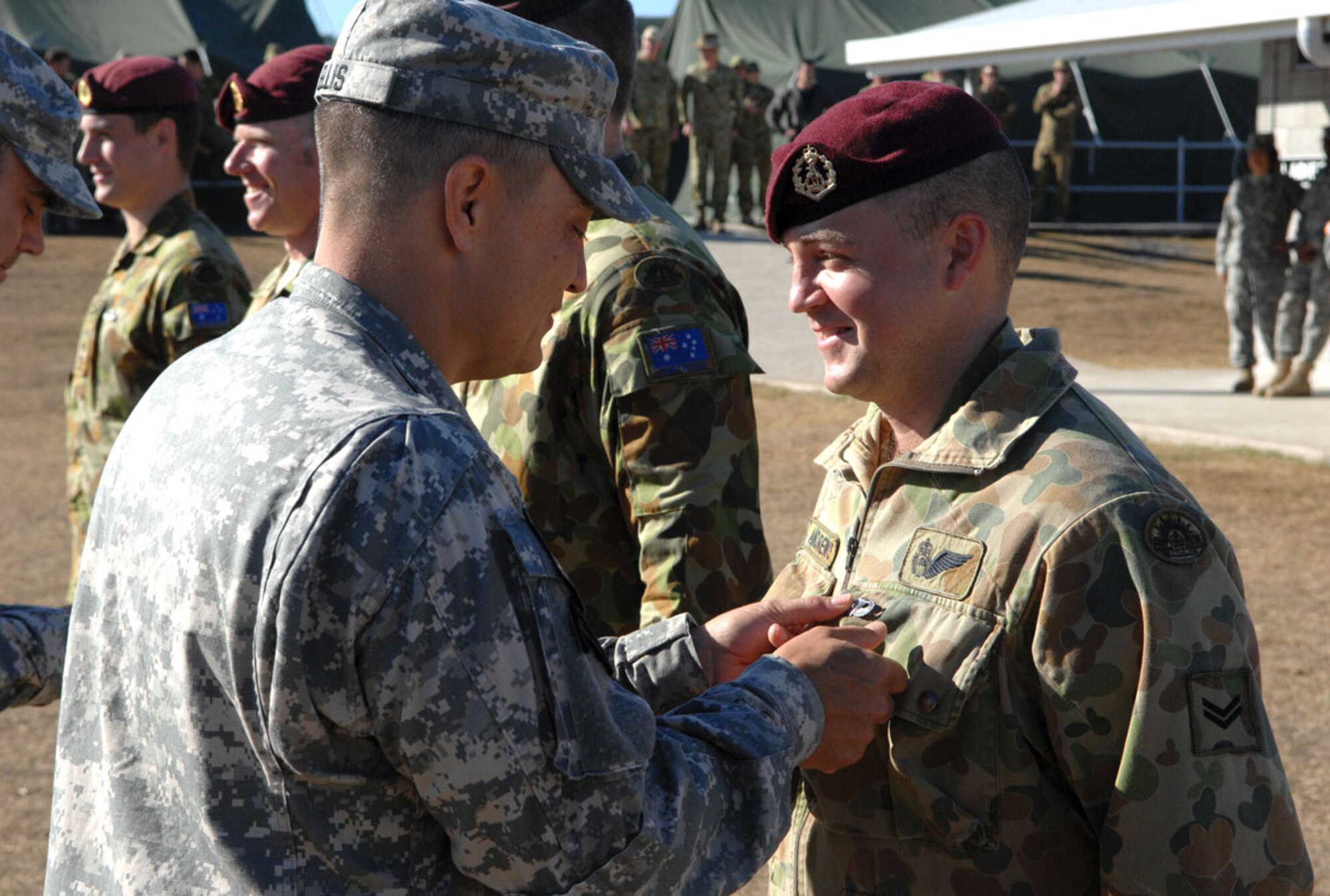 The four Australian jumpmasters who jumped with the American task force from Alaska were presented U.S. jump wings by U.S. Army Lt. Col. Patrick Ellis, commander of the 1st Battalion (Airborne), 501st Parachute Infantry Regiment, as part of a traditional military exchange between the two airborne units. (U.S. Army photo/Staff Sgt. Matthew E. Winstead)
