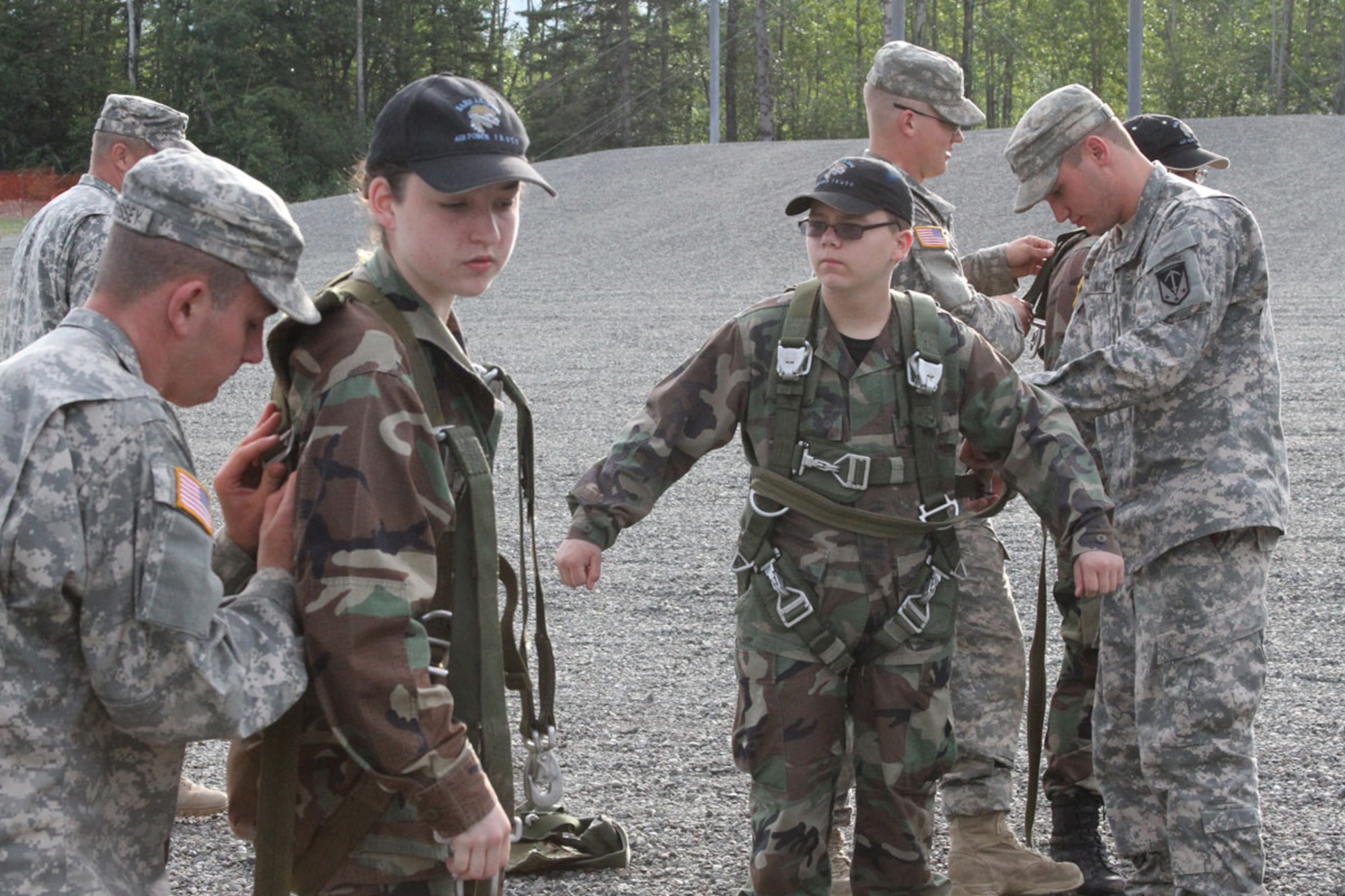 Soldiers of the 6th Engineer Battalion (Combat) (Airborne) Arctic Sappers rig and inspect jump harnesses on cadets from the South Anchorage High School JROTC program during a visit to Joint Base Elmendorf-Richardson, July 29.  (U.S. Army photo/Staff Sgt. Jason Epperson)