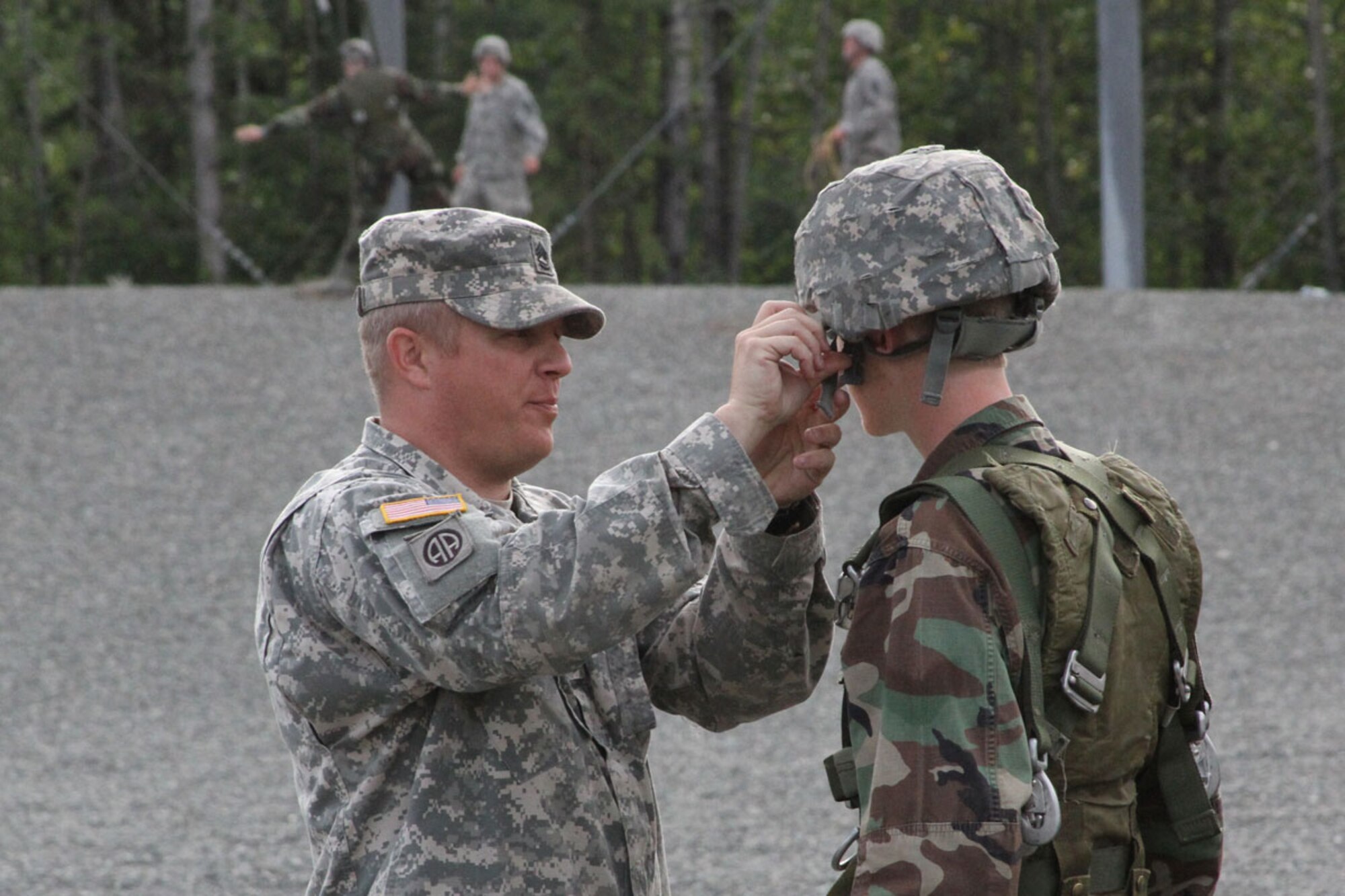 Sgt. 1st Class Sean Foley, Forward Support Company, 6th Engineer Battalion (Combat) (Airborne), inspects a cadet to ensure proper safety standards are met prior to a jump from the 34-foot-tower at Joint Base Elmendorf-Richardson, July 29. (U.S. Army photo/Staff Sgt. Jason Epperson)