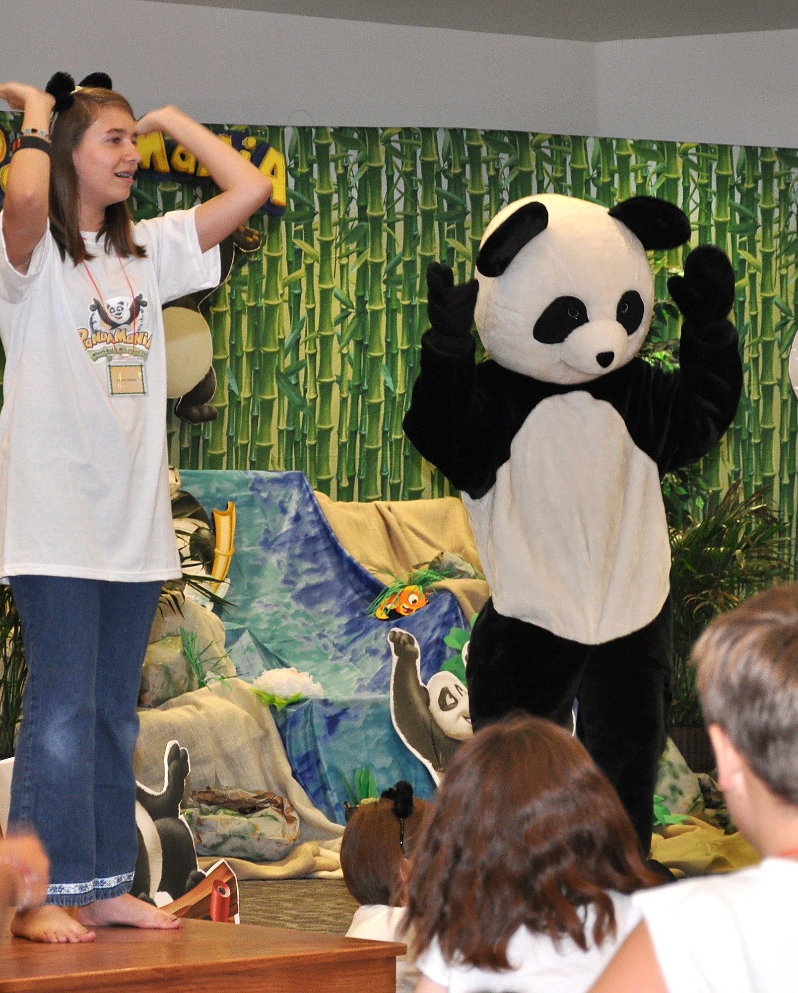 GOODFELLOW AIR FORCE BASE, Texas -- (From left:) Amber Mantel and Panda Pete sing and dance at the start of Pandamania Vacation Bible School Aug. 3 at the base chapel here.  More than 40 youths were enrolled in the three-day VBS.  (U.S. Air Force photo/Connie Hempel)