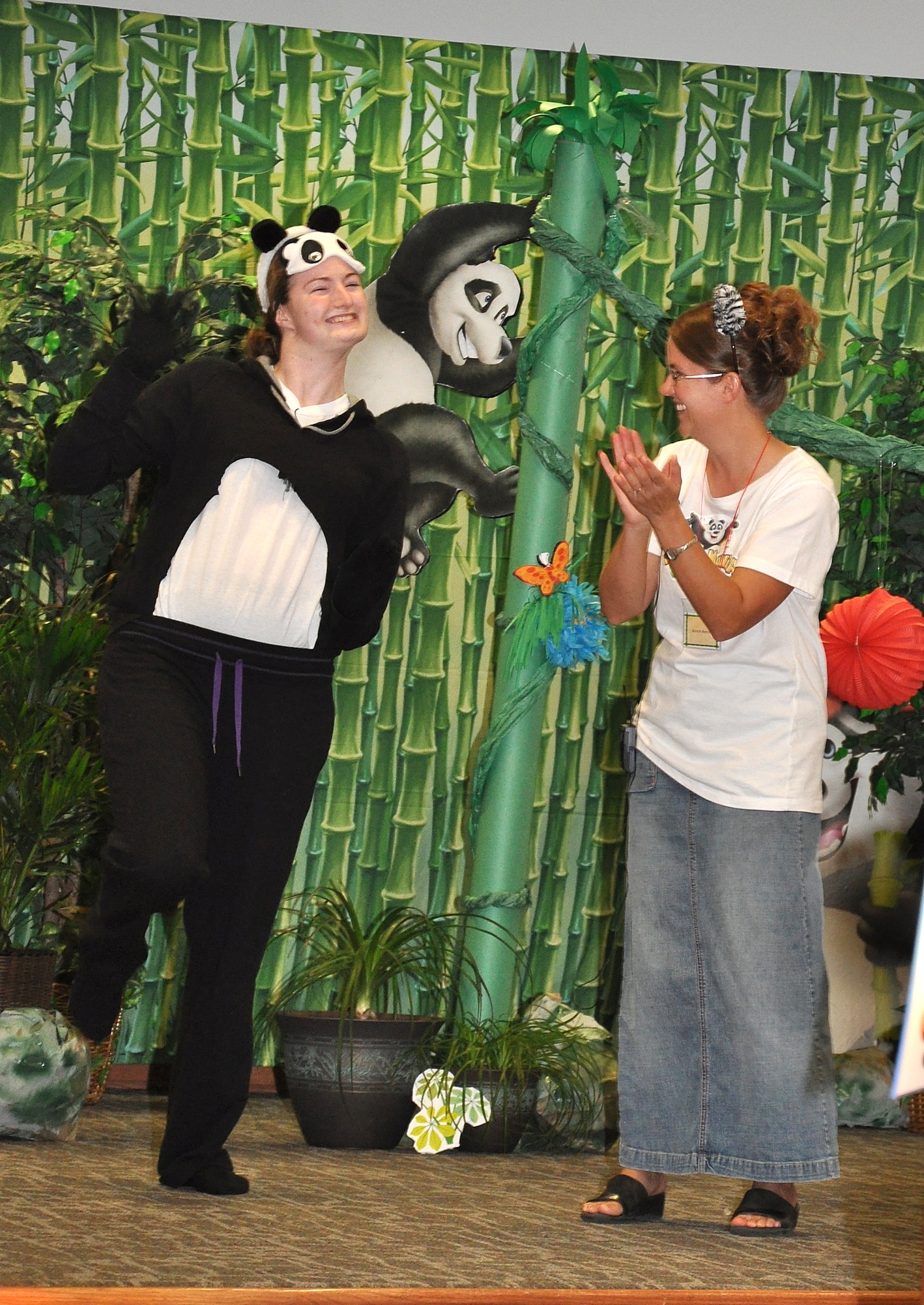 GOODFELLOW AIR FORCE BASE, Texas -- (From left:) Rachael Price acts as Penny the Panda while she and Bonnie Averett sing and dance at the start of Pandamania Vacation Bible School Aug. 3 at the base chapel here.  More than 40 youths were enrolled in the three-day VBS.  (U.S. Air Force photo/Connie Hempel)