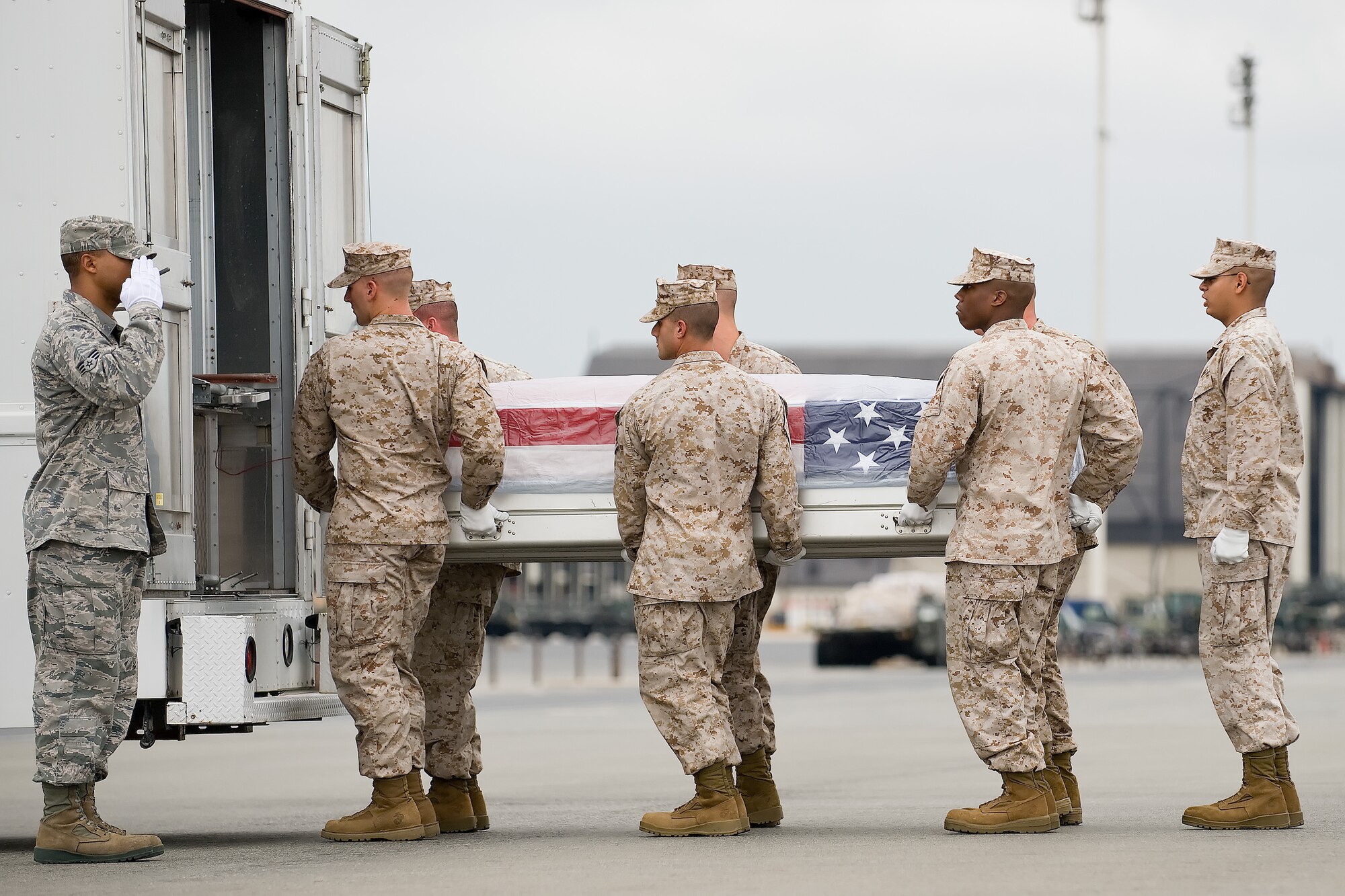 A U.S. Marine Corps carry team transfers the remains of Marine Staff Sgt. Leon H. Lucas Jr. of Wilson, N.C., at Dover Air Force Base, Del., Aug. 4, 2011. He was assigned to 3rd Battalion, 4th Marine Regiment, 1st Marine Division, I Marine Expeditionary Force, Twentynine Palms, Calif. (U.S. Air Force photo/Adrian Rowan)