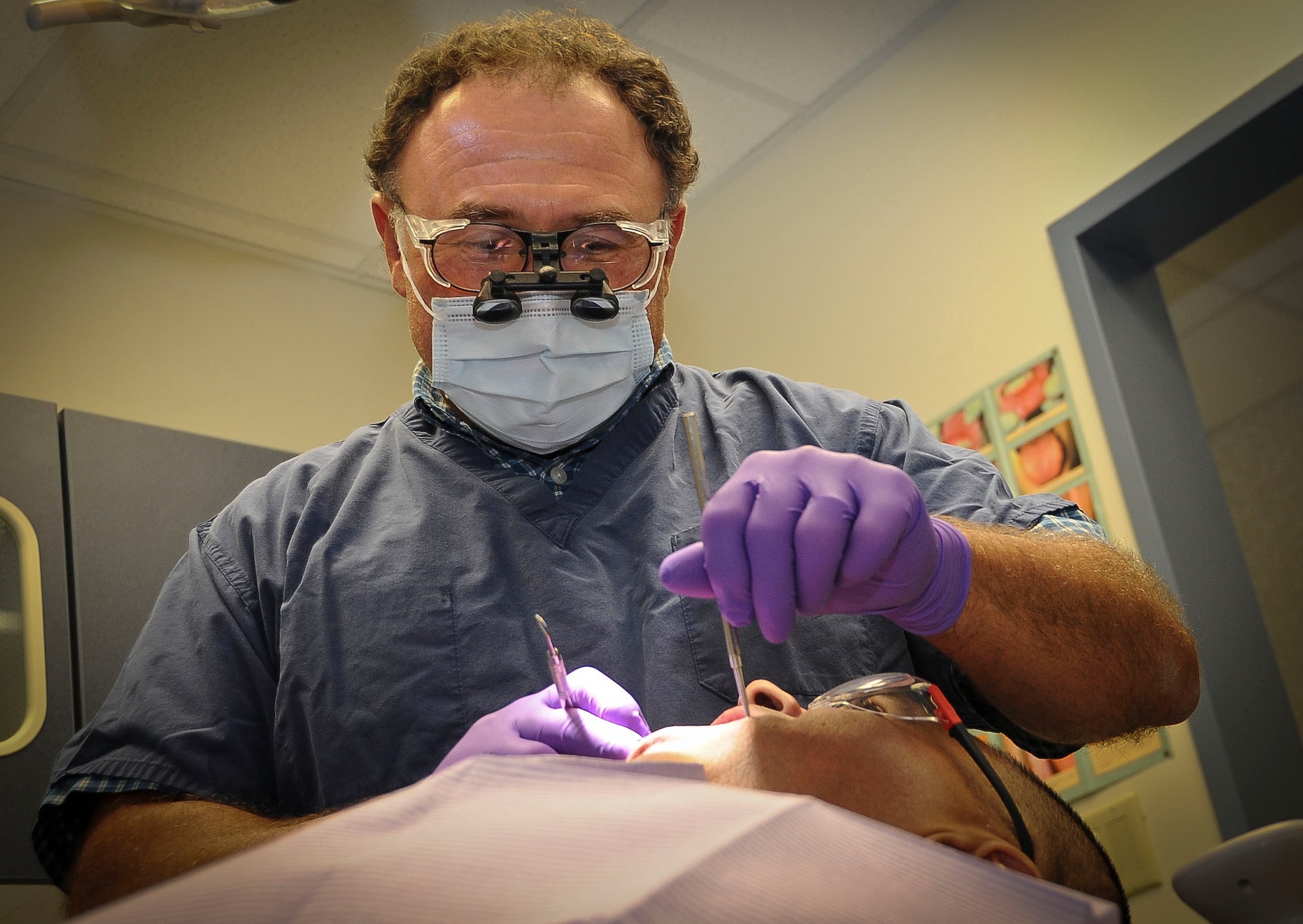 George Woronkodds, Joint Base McGuire-Dix-Lakehurst Dental Clinic general dentist, has been brought on to assist at the Joint Base Dental Clinic which now serves Air Force, Army, Marine, Navy and Coast Guard servicemembers. He joins the team every Tuesday to assist with dental examinations, restorative, general and oral surgery procedures. (U.S. Air Force photo by Airman 1st Class Dennis Sloan/Released)
