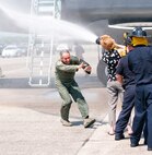 Col. Robert Swain Jr., 439th Airlift Wing commander, flew his final C-5 mission Aug. 3. Dozens of onlookers awaited the conclusion of the commander's fini flight, including his wife, Diane Swain, who used a large hose from the Westover Fire Department to douse her husband shortly after he stepped down the crew ladder from the C-5. The fini flight adds to the colonel's more than 3,500 hours flying C-5s and A-10s -- including 51 combat missions over Southwest Asia. Swain is the first pilot to score an air-to-air kill in an A-10 Thunderbolt II, when he downed an Iraqi helicopter during Operation Desert Storm. He will relinquish command of the 439th AW Aug. 6 to Col. Steven Vautrain. (US Air Force photo/W.C.pope)
