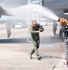 Col. Robert Swain Jr., 439th Airlift Wing commander, flew his final C-5 mission Aug. 3. Dozens of onlookers awaited the conclusion of the commander's fini flight, including his wife, Diane Swain, who used a large hose from the Westover Fire Department to douse her husband shortly after he stepped down the crew ladder from the C-5. The fini flight adds to the colonel's more than 3,500 hours flying C-5s and A-10s -- including 51 combat missions over Southwest Asia. Swain is the first pilot to score an air-to-air kill in an A-10 Thunderbolt II, when he downed an Iraqi helicopter during Operation Desert Storm. He will relinquish command of the 439th AW Aug. 6 to Col. Steven Vautrain. (US Air Force photo/W.C.pope)