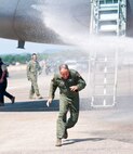 Col. Robert Swain Jr., 439th Airlift Wing commander, flew his final C-5 mission Aug. 3. Dozens of onlookers awaited the conclusion of the commander's fini flight, including his wife, Diane Swain, who used a large hose from the Westover Fire Department to douse her husband shortly after he stepped down the crew ladder from the C-5. The fini flight adds to the colonel's more than 3,500 hours flying C-5s and A-10s -- including 51 combat missions over Southwest Asia. Swain is the first pilot to score an air-to-air kill in an A-10 Thunderbolt II, when he downed an Iraqi helicopter during Operation Desert Storm. He will relinquish command of the 439th AW Aug. 6 to Col. Steven Vautrain. (US Air Force photo/W.C.pope)