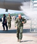 Col. Robert Swain Jr., 439th Airlift Wing commander, flew his final C-5 mission Aug. 3. Dozens of onlookers awaited the conclusion of the commander's fini flight, including his wife, Diane Swain, who used a large hose from the Westover Fire Department to douse her husband shortly after he stepped down the crew ladder from the C-5. The fini flight adds to the colonel's more than 3,500 hours flying C-5s and A-10s -- including 51 combat missions over Southwest Asia. Swain is the first pilot to score an air-to-air kill in an A-10 Thunderbolt II, when he downed an Iraqi helicopter during Operation Desert Storm. He will relinquish command of the 439th AW Aug. 6 to Col. Steven Vautrain. (US Air Force photo/W.C.pope)