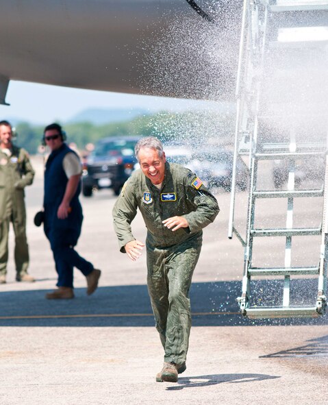 Col. Robert Swain Jr., 439th Airlift Wing commander, flew his final C-5 mission Aug. 3. Dozens of onlookers awaited the conclusion of the commander's fini flight, including his wife, Diane Swain, who used a large hose from the Westover Fire Department to douse her husband shortly after he stepped down the crew ladder from the C-5. The fini flight adds to the colonel's more than 3,500 hours flying C-5s and A-10s -- including 51 combat missions over Southwest Asia. Swain is the first pilot to score an air-to-air kill in an A-10 Thunderbolt II, when he downed an Iraqi helicopter during Operation Desert Storm. He will relinquish command of the 439th AW Aug. 6 to Col. Steven Vautrain. (US Air Force photo/W.C.pope)