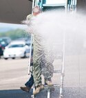 Col. Robert Swain Jr., 439th Airlift Wing commander, flew his final C-5 mission Aug. 3. Dozens of onlookers awaited the conclusion of the commander's fini flight, including his wife, Diane Swain, who used a large hose from the Westover Fire Department to douse her husband shortly after he stepped down the crew ladder from the C-5. The fini flight adds to the colonel's more than 3,500 hours flying C-5s and A-10s -- including 51 combat missions over Southwest Asia. Swain is the first pilot to score an air-to-air kill in an A-10 Thunderbolt II, when he downed an Iraqi helicopter during Operation Desert Storm. He will relinquish command of the 439th AW Aug. 6 to Col. Steven Vautrain. (US Air Force photo/W.C.pope)