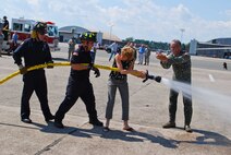 Col. Robert Swain Jr., 439th Airlift Wing commander, flew his final C-5 mission Aug. 3. Dozens of onlookers awaited the conclusion of the commander's fini flight, including his wife, Diane Swain, who used a large hose from the Westover Fire Department to douse her husband shortly after he stepped down the crew ladder from the C-5. The fini flight adds to the colonel's more than 3,500 hours flying C-5s and A-10s -- including 51 combat missions over Southwest Asia. Swain is the first pilot to score an air-to-air kill in an A-10 Thunderbolt II, when he downed an Iraqi helicopter during Operation Desert Storm. He will relinquish command of the 439th AW Aug. 6 to Col. Steven Vautrain. (US Air Force photo/Master Sgt. Andrew Biscoe)