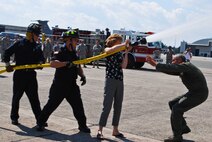 Col. Robert Swain Jr., 439th Airlift Wing commander, flew his final C-5 mission Aug. 3. Dozens of onlookers awaited the conclusion of the commander's fini flight, including his wife, Diane Swain, who used a large hose from the Westover Fire Department to douse her husband shortly after he stepped down the crew ladder from the C-5. The fini flight adds to the colonel's more than 3,500 hours flying C-5s and A-10s -- including 51 combat missions over Southwest Asia. Swain is the first pilot to score an air-to-air kill in an A-10 Thunderbolt II, when he downed an Iraqi helicopter during Operation Desert Storm. He will relinquish command of the 439th AW Aug. 6 to Col. Steven Vautrain. (US Air Force photo/Master Sgt. Andrew Biscoe)