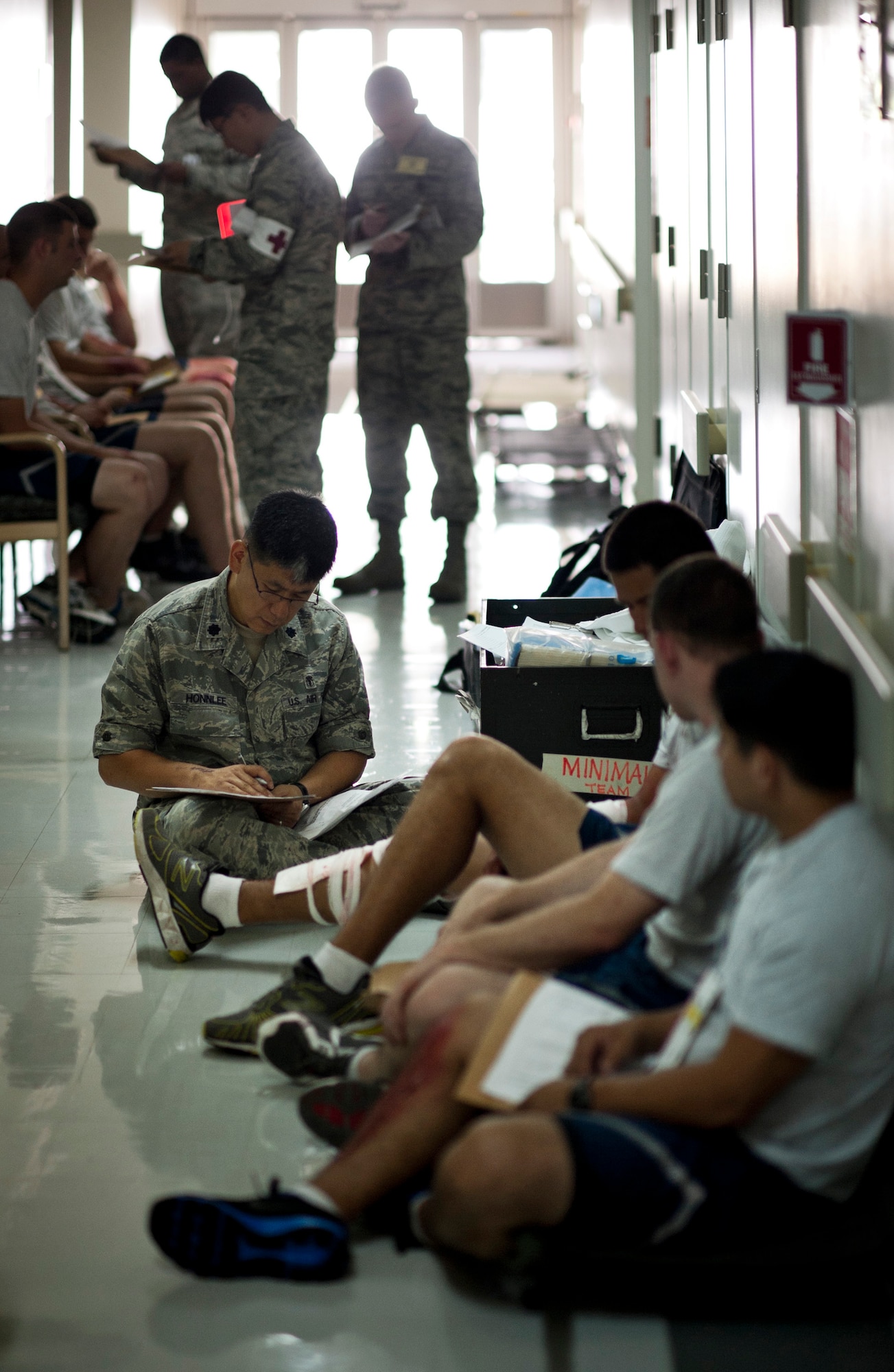 YOKOTA AIR BASE, Japan -- Lt. Col. Jason Honnlee, 374th Dental Squadron, writes down patient information for simulated explosion victims during an emergency management exercise at Yokota Air Base, Japan, Aug. 4, 2011. The staff at the 374th Medical Group had to decontaminate, manage and treat approximately 30 simulated victims during the exercise. (U.S. Air Force photo/Staff Sgt. Samuel Morse)