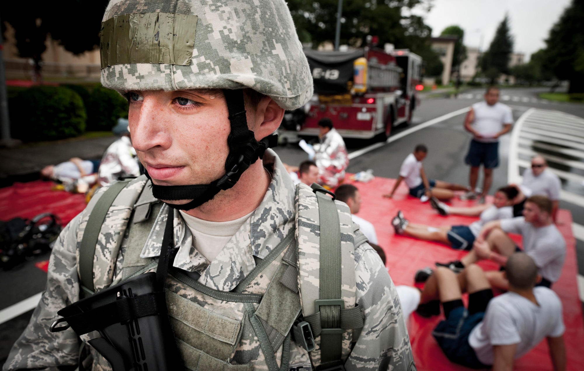 YOKOTA AIR BASE, Japan -- Airman Bryce Edington, 374th Security Forces Squadron, stands guard while directing traffic around simulated victims of a simulated explosion during an emergency management exercise at Yokota Air Base, Japan, Aug. 4, 2011. The exercise gave Yokota's emergency responders a chance to practice managing the various complexities of mass casualty scenario. (U.S. Air Force photo/Staff Sgt. Samuel Morse)