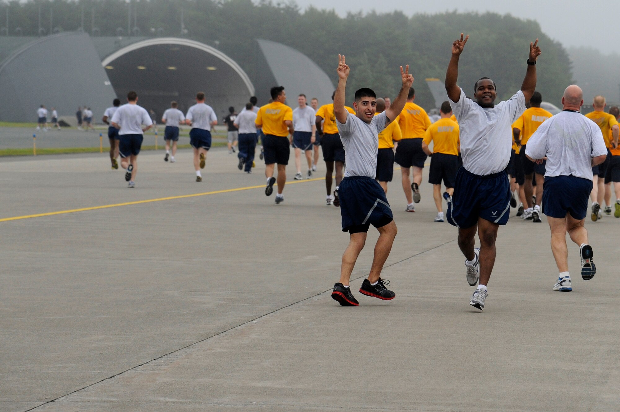 MISAWA AIR BASE, Japan -- Airmen celebrate their finish of the monthly readiness run held on the flightline Aug. 5th.  Readiness runs are not normally held on the flightline so this time runners had the opportunity to see a part of the flightline that they normally wouldn't get to see. (U.S. Air Force photo/Staff Sgt. Marie Brown)