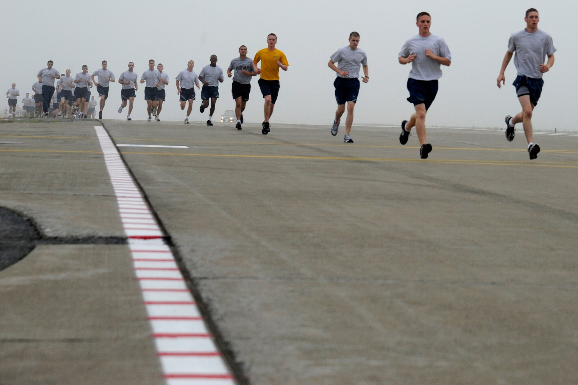 MISAWA AIR BASE, Japan -- Airmen and Sailors run on the flightline during the monthly readiness run Aug. 5th. This month's run was hosted by the 35th Maintenance Group and was held on the flightline. (U.S. Air Force photo/Staff Sgt. Marie Brown)