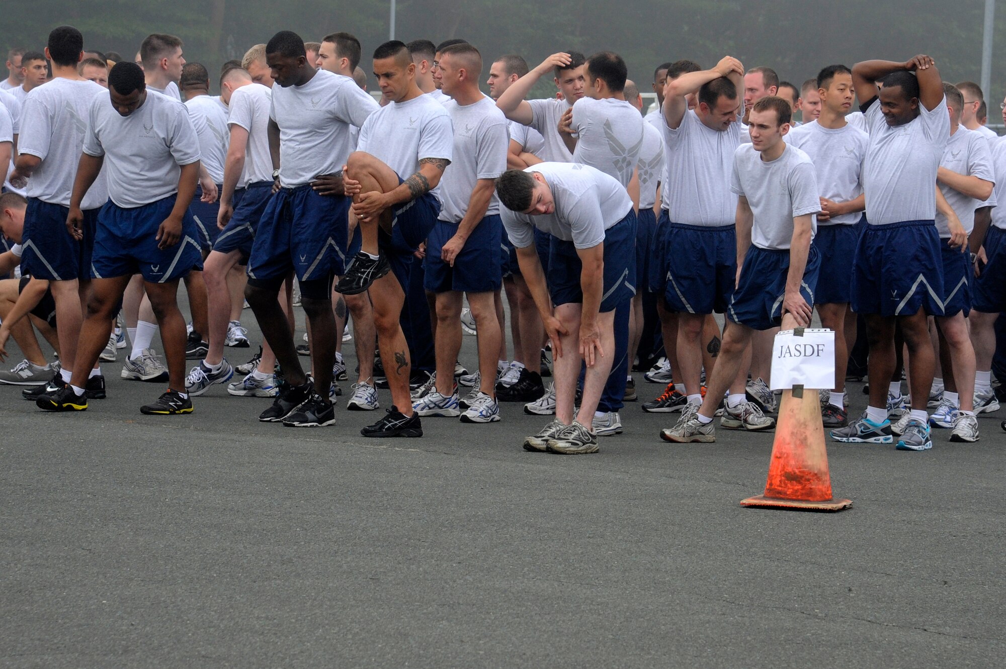 MISAWA AIR BASE, Japan -- Airmen from the 35th Fighter Wing take time to stretch before the start of the monthly readiness run Aug. 5th. Airmen are encouraged to stretch before and after exercising to loosen up tight muscles in order to prevent injury. (U.S. Air Force photo/Staff Sgt. Marie Brown)