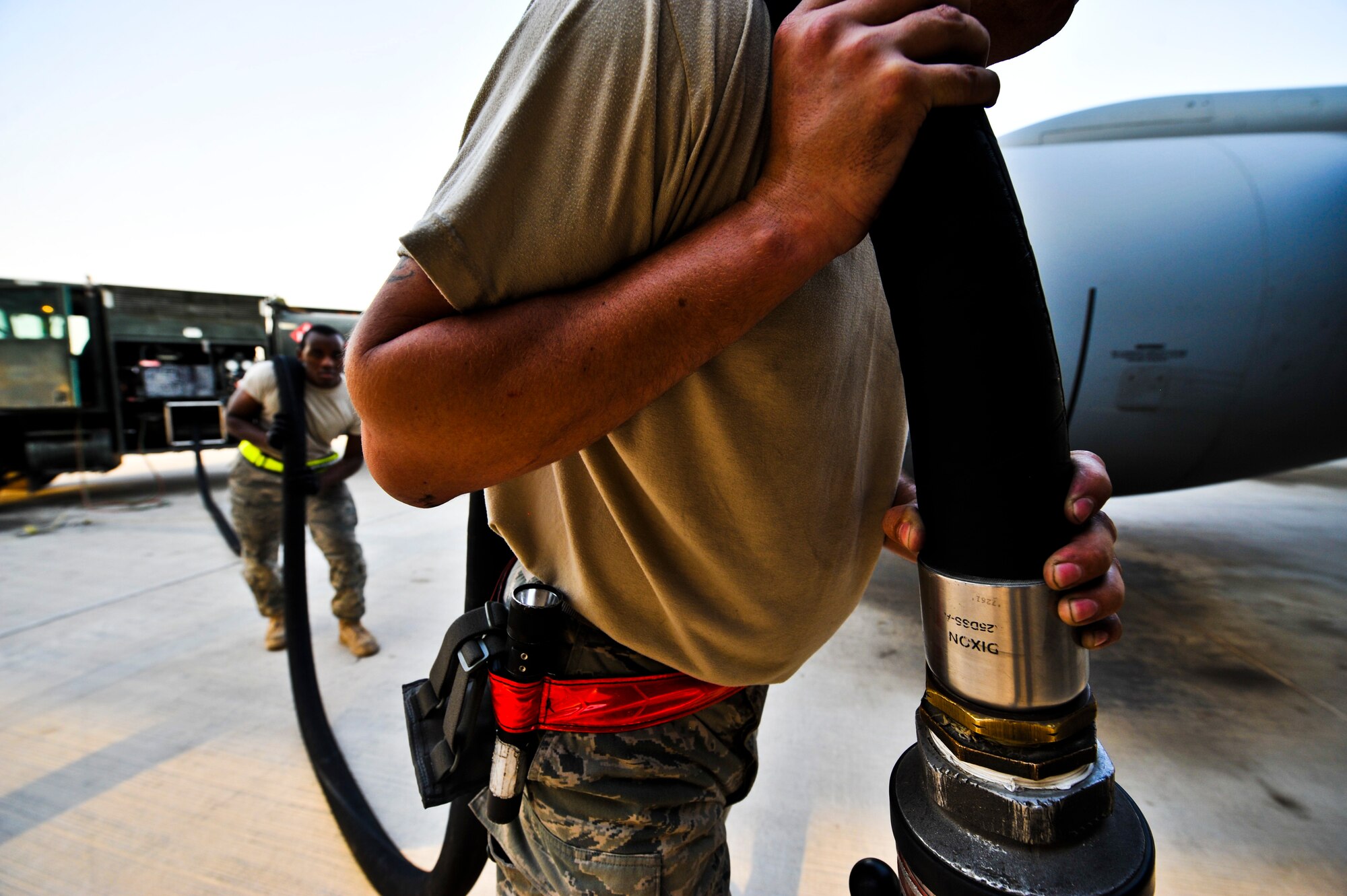 Staff Sgt. Jesse Fuller, 340th Expeditionary Aircraft Maintenance Unit crew chief, (foreground) and Senior Airman Kevin Arnold, 379th Expeditionary Logistics Readiness Squadron, prepare to refuel a KC-135 Stratotanker, July 31, at an undisclosed location in Southwest Asia.  Fuller is deployed from McConnell Air Force Base, Kan., and Arnold is deployed from McGuire Air Force Base, N.J.  (U.S. Air Force photo/Senior Airman Paul Labbe)