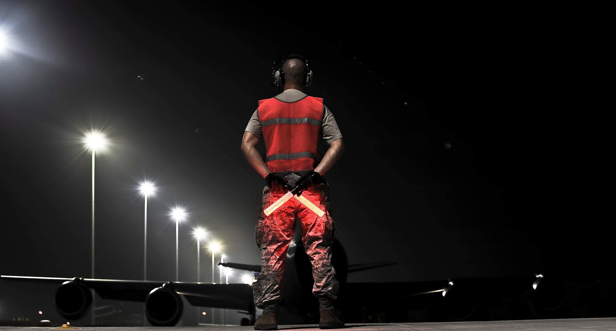 Staff Sgt. Justin Dahlmann, 340th Expeditionary Aircraft Maintenance Unit crew chief, waits to marshal out a KC-135 Stratotanker, July 31, at an undisclosed location in Southwest Asia.  Dahlmann is deployed from McConnell Air Force Base, Kan. (U.S. Air Force photo/Senior Airman Paul Labbe)
