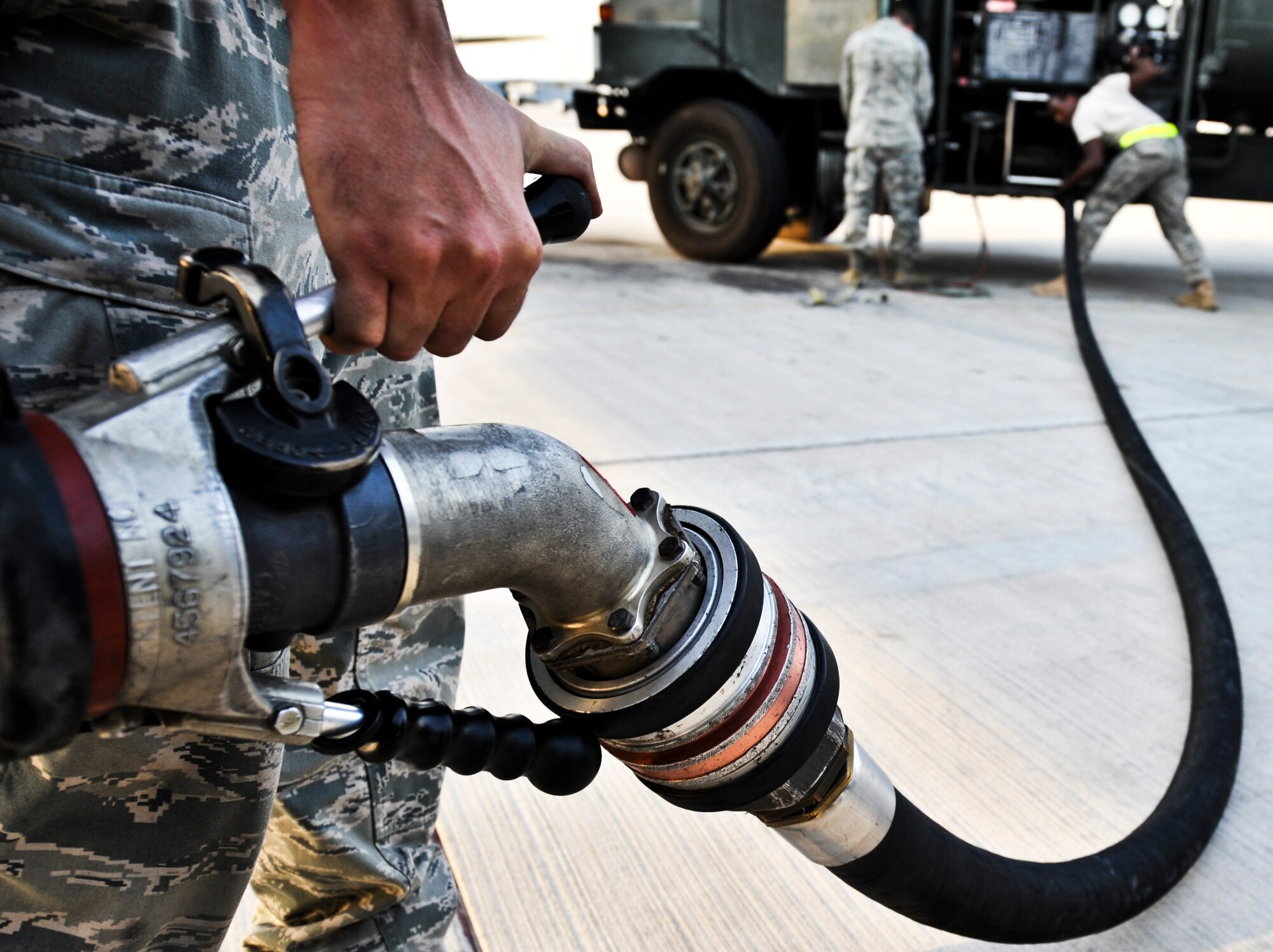 Airmen from the 340th Expeditionary Aircraft Maintenance Unit and 379th Expeditionary Logistics Readiness Squadron retract a refueling hose, July 31, at an undisclosed location in Southwest Asia. (U.S. Air Force photo/Senior Airman Paul Labbe)
 