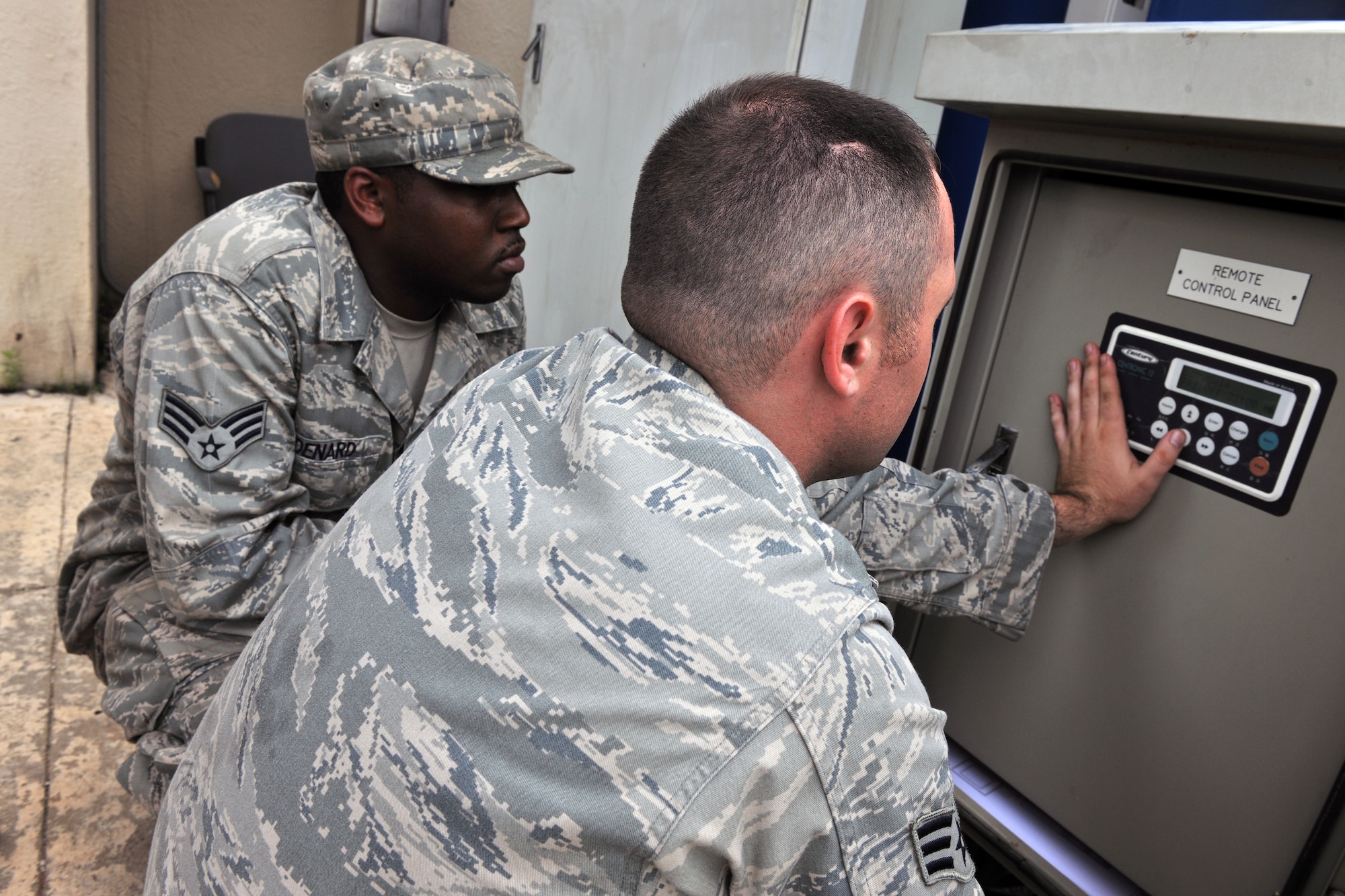 KUNSAN AIR BASE, Republic of Korea -- Senior Airman Edgar Denard and SrA Jonathan Pears, 8th Civil Engineer Squadron heating, ventilating, air conditioning and refrigerating technicians, adjust system controls here Aug. 4. They maintain 1.7K HVAC/R Systems base-wide and assist the Army with specialized air conditioning equipment. (U.S. Air Force photo/Senior Airman Brittany Y. Bateman)