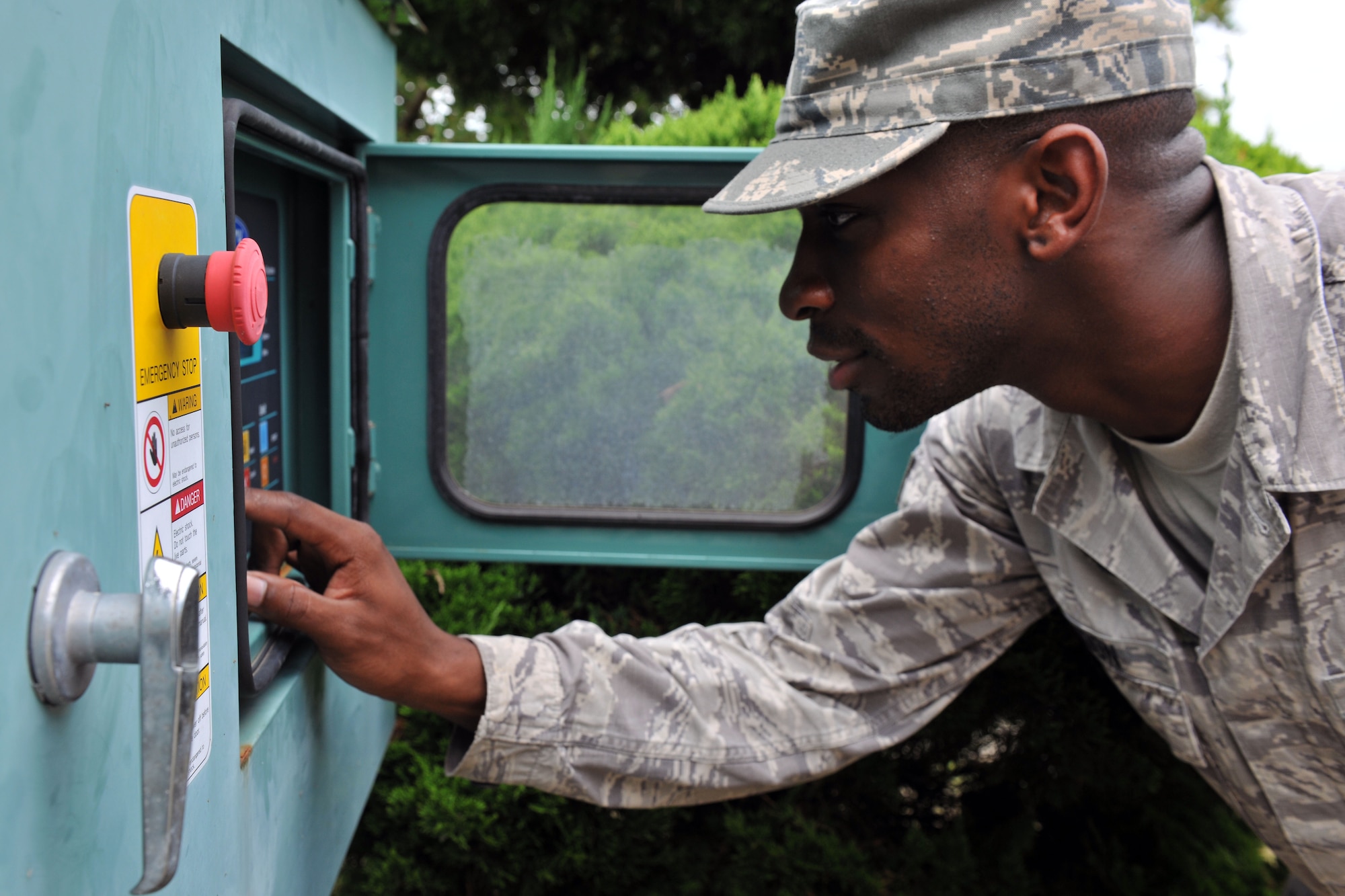 KUNSAN AIR BASE, Republic of Korea -- Senior Airman Myron Gordan, 8th Civil Engineer Squadron heating, ventilating, air conditioning and refrigerating technician, adjusts system controls here Aug. 4. They maintain 1.7K HVAC/R Systems base wide and assist Army with specialized air conditioning equipment. (U.S. Air Force photo/Senior Airman Brittany Y. Bateman)