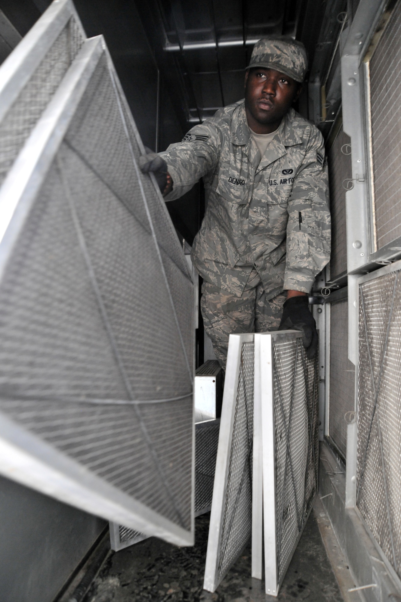 KUNSAN AIR BASE, Republic of Korea -- Senior Airman Edgar Denard, 8th Civil Engineer Squadron heating, ventilating, air conditioning and refrigerating technician, changes filters on a system here Aug. 4. HVAC Airmen maintain 1.7K HVAC/R Systems base wide and assist Army with specialized air conditioning equipment.  (U.S. Air Force photo/Senior Airman Brittany Y. Bateman)